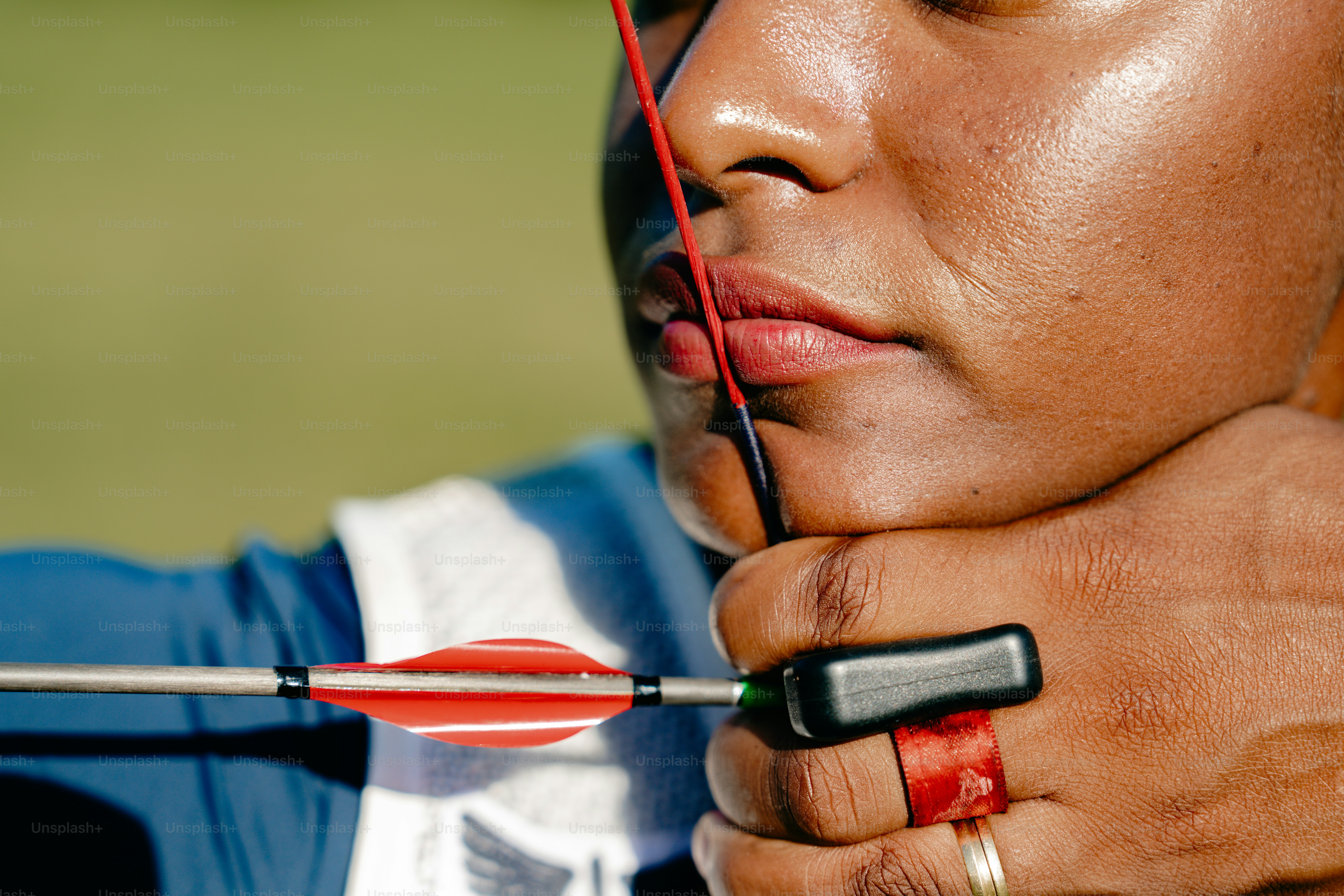 A woman is holding a red arrow in her hand photo – Athlete Image on ...