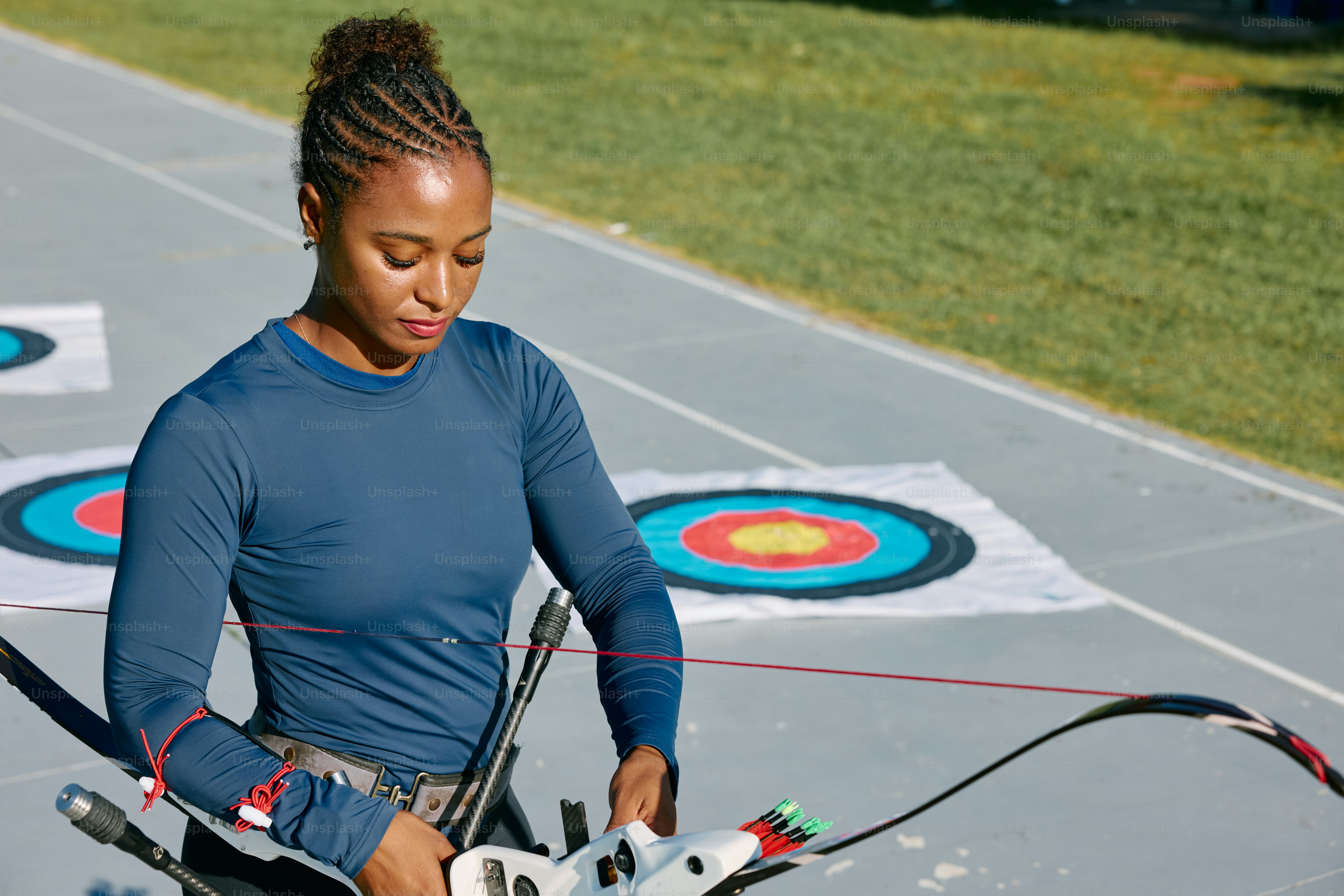 a woman holding a bow and arrow in her hands