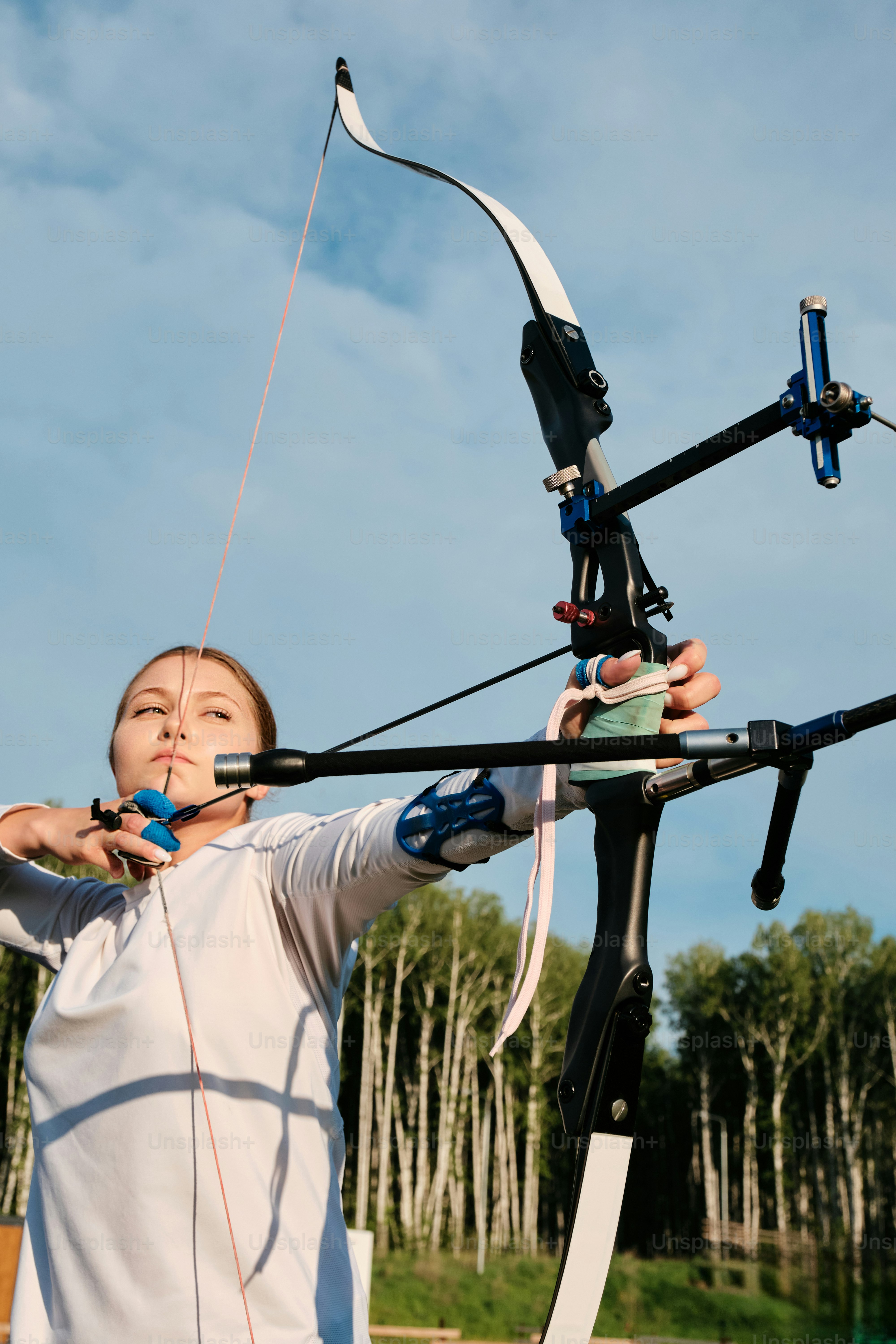 a woman holding a bow and arrow in her hands