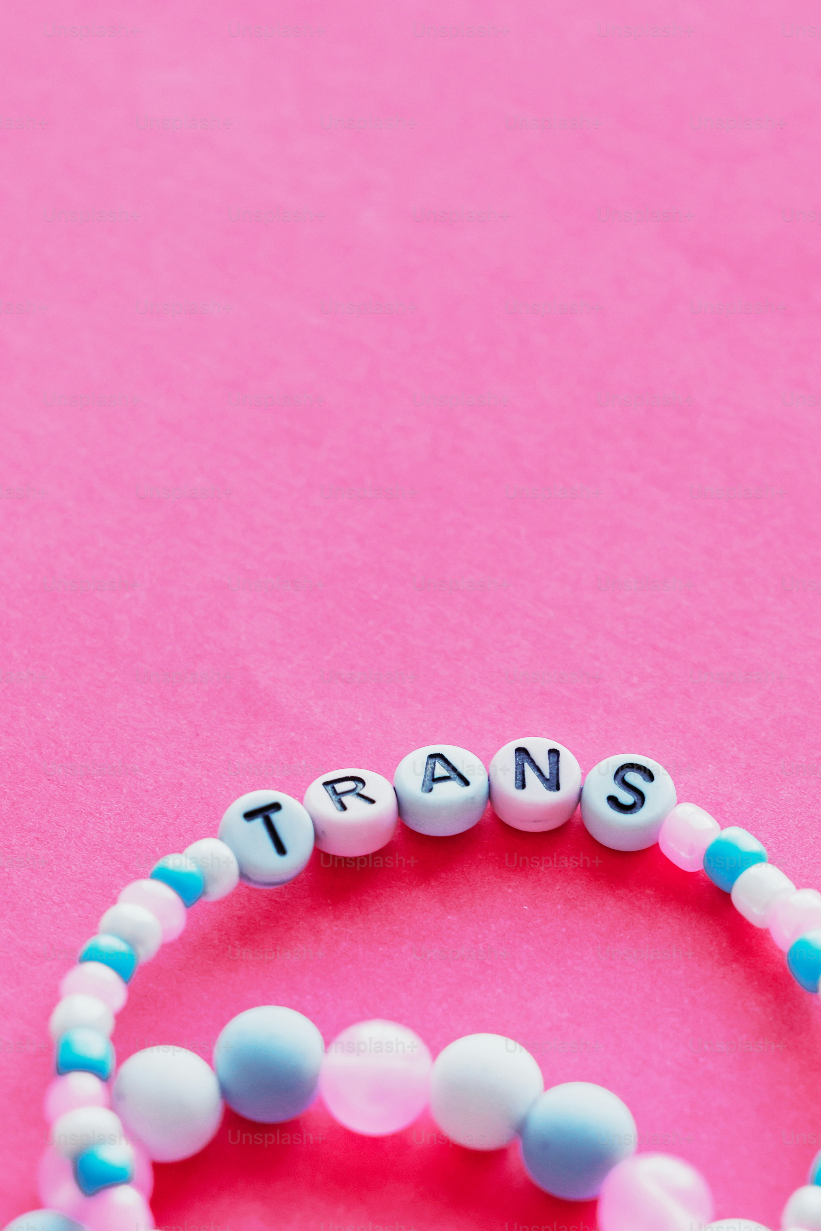Two bracelets with the word transs written on them