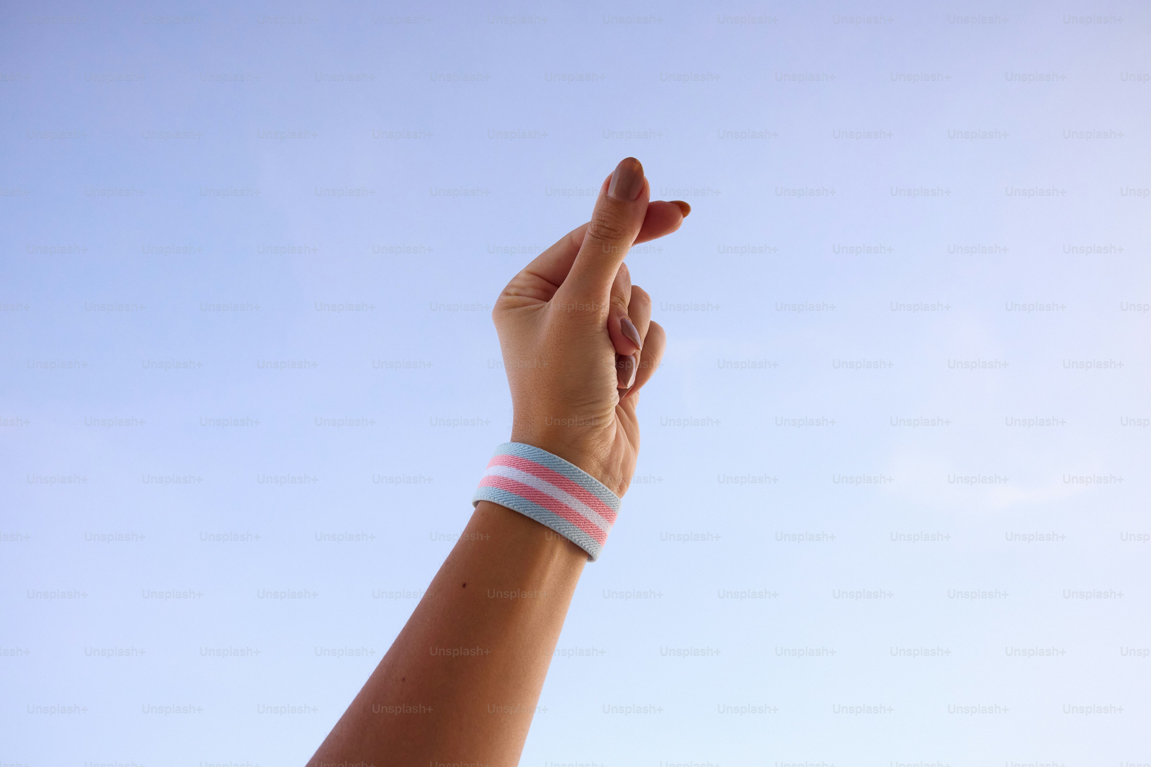 A person's hand reaching up into the sky