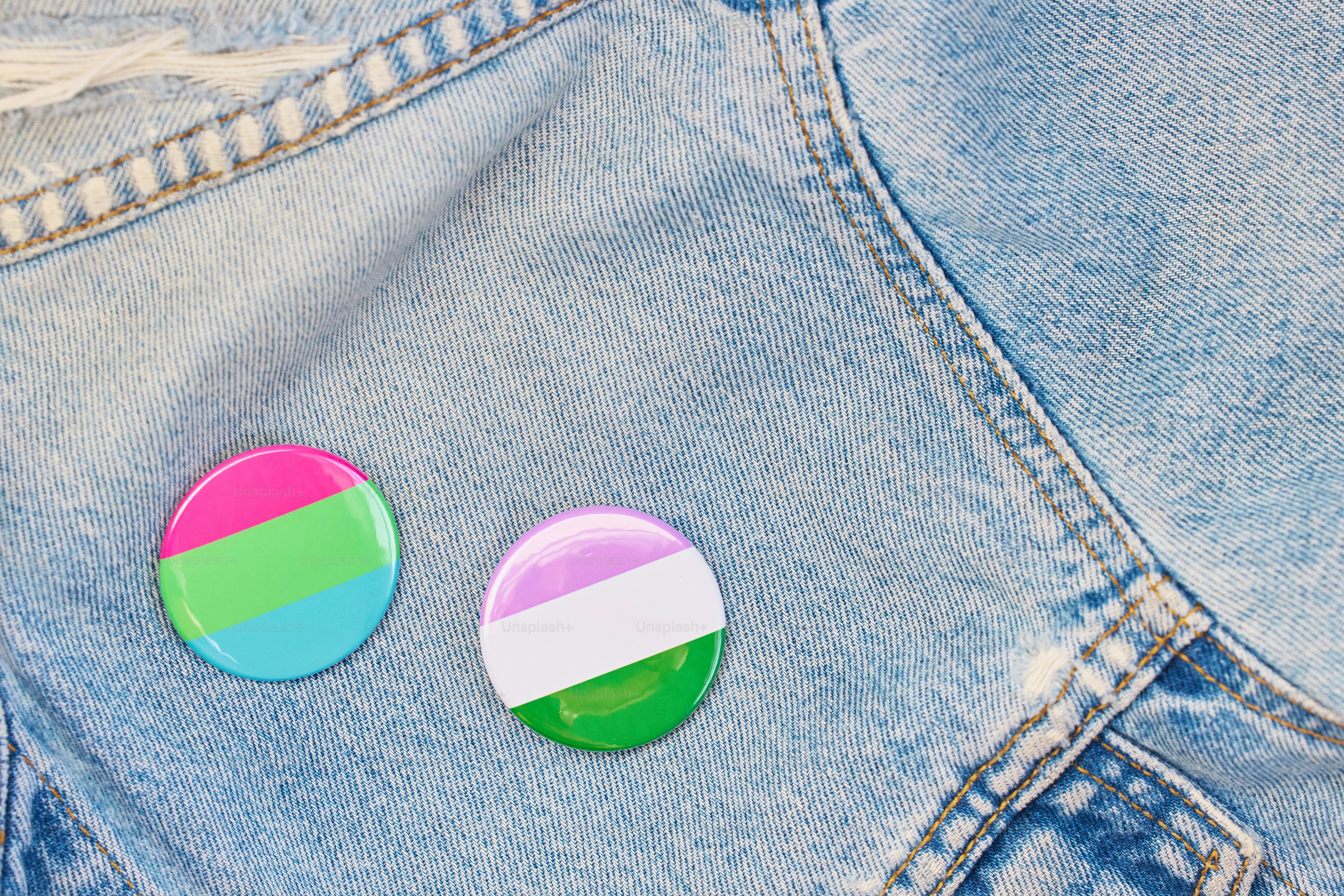 A pair of buttons sitting on a pair of jean shorts