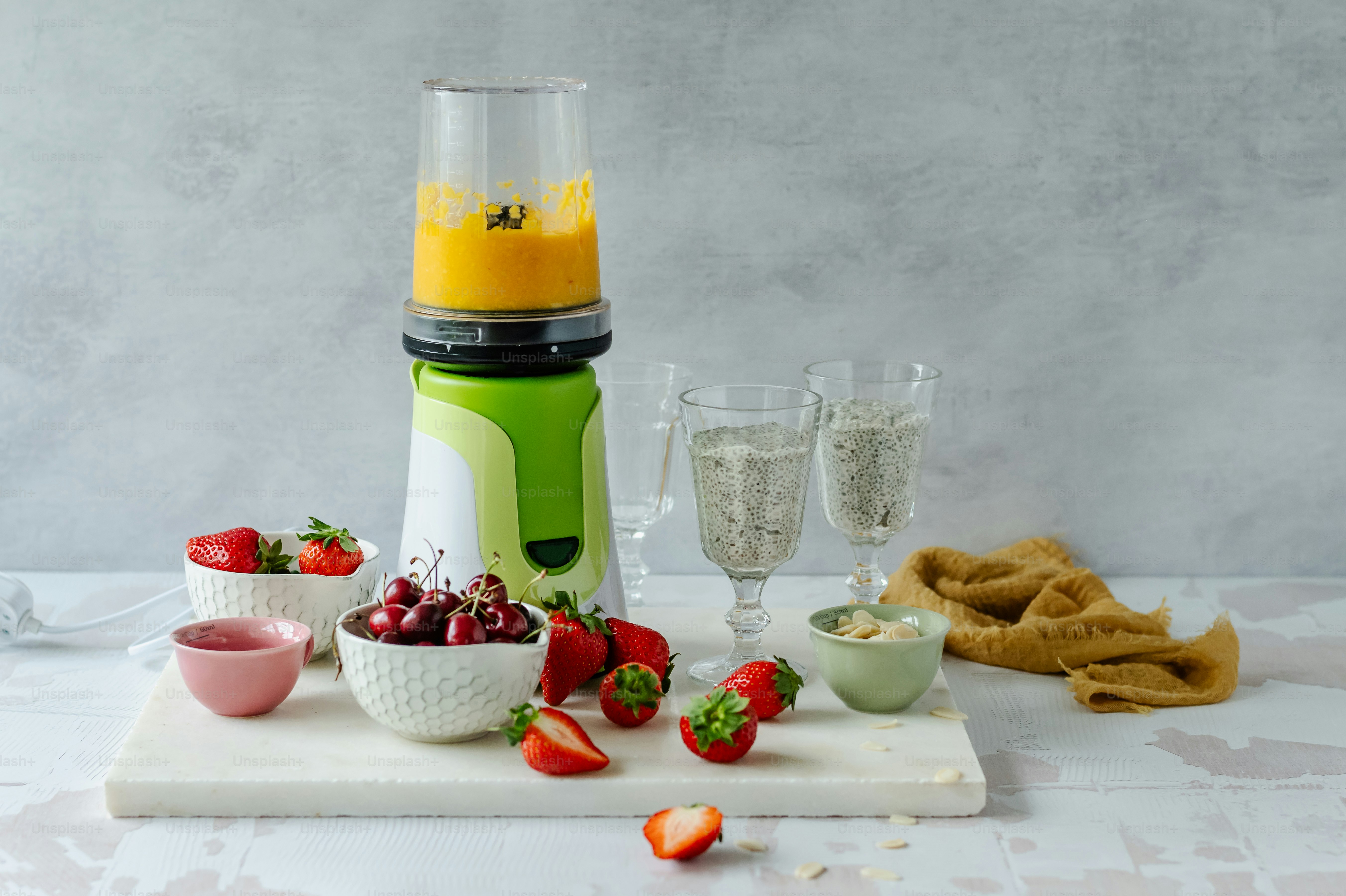 a blender sitting on top of a cutting board filled with fruit