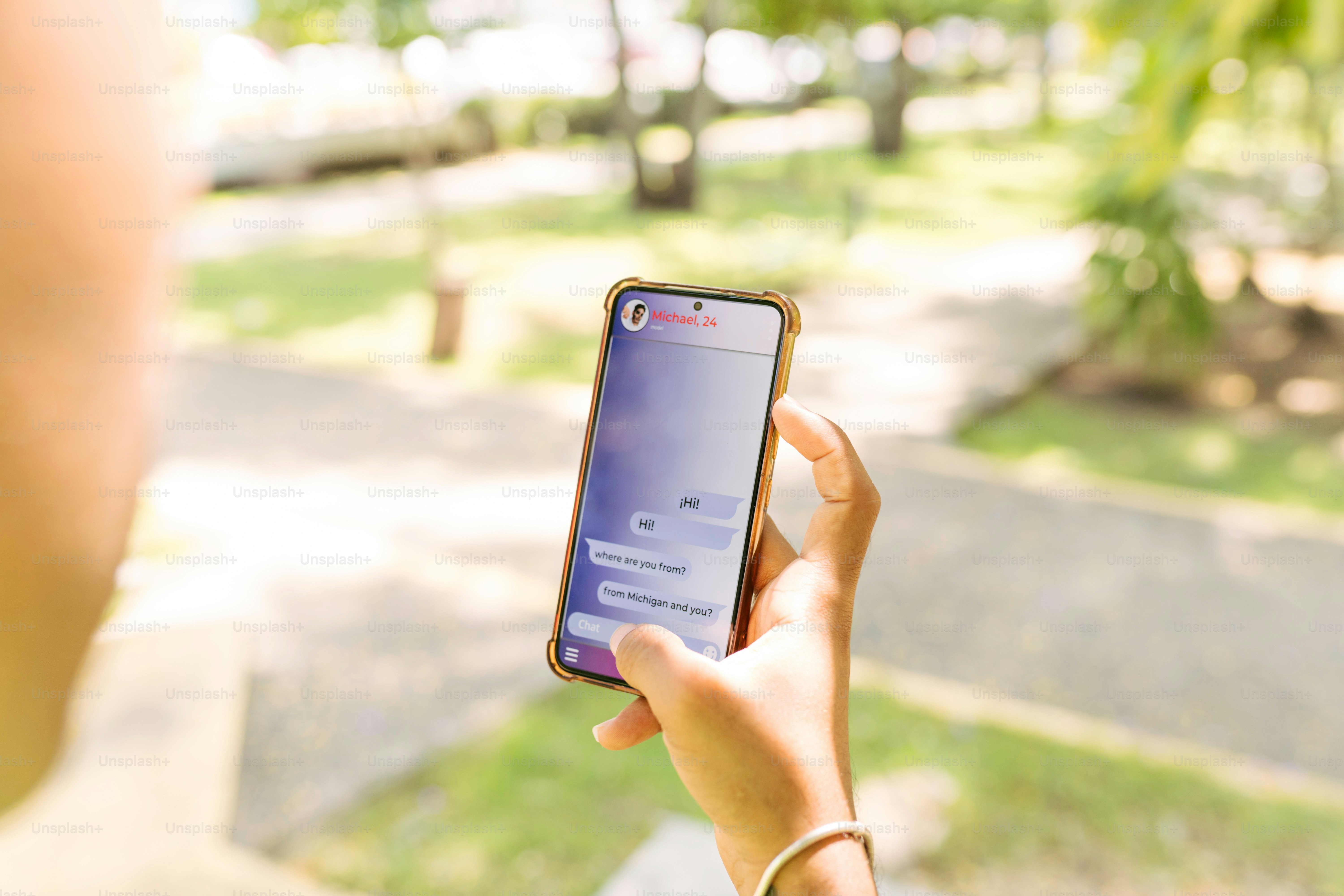 A person holding a cell phone in their hand