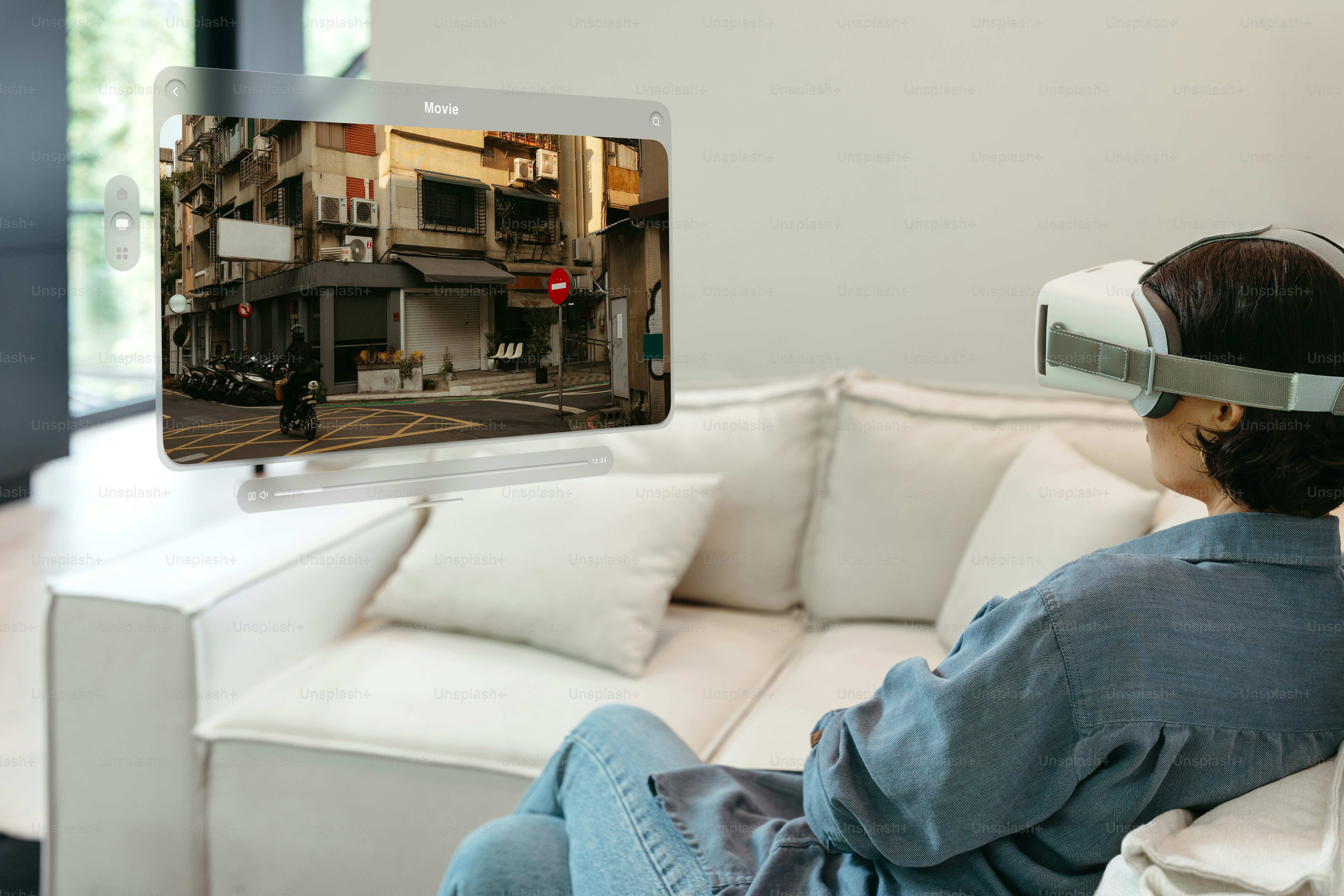 A man sitting on a couch in front of a flat screen TV