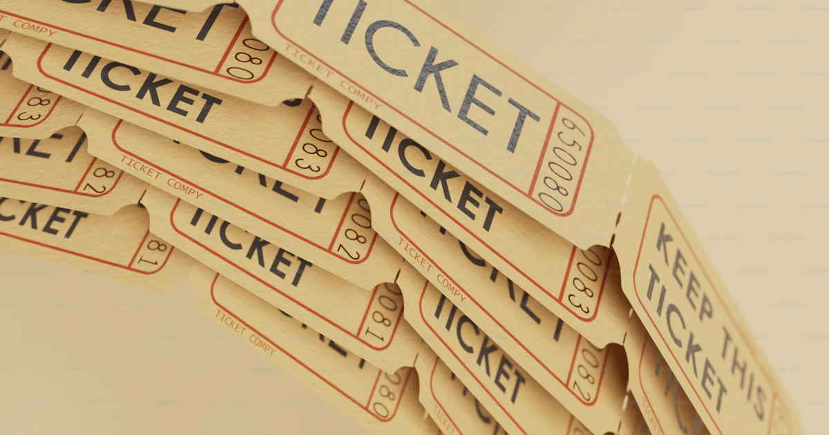 A stack of tickets sitting on top of a table photo – Raffle tickets ...