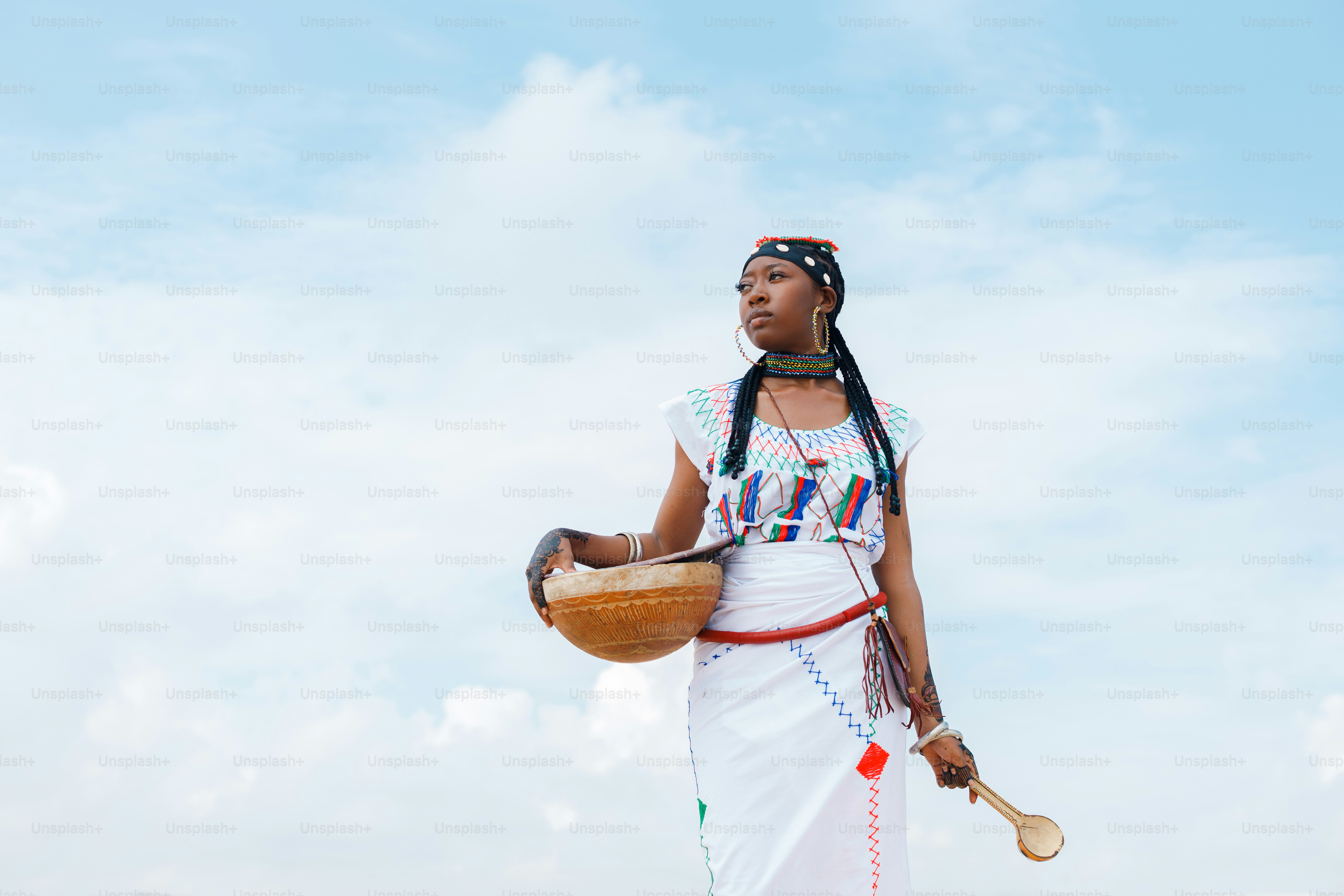 A woman in a white dress holding a basket