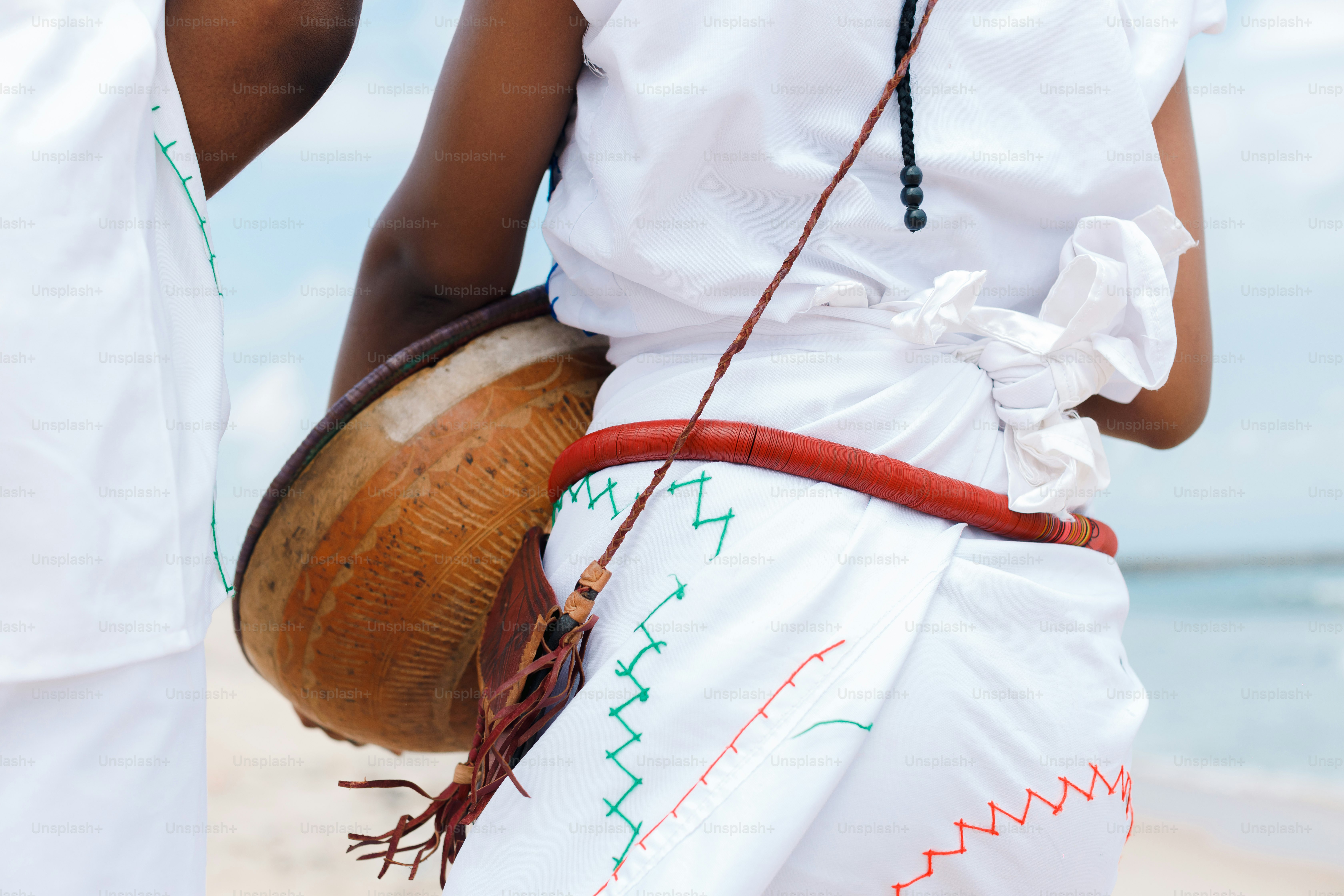 A couple of people standing on top of a beach