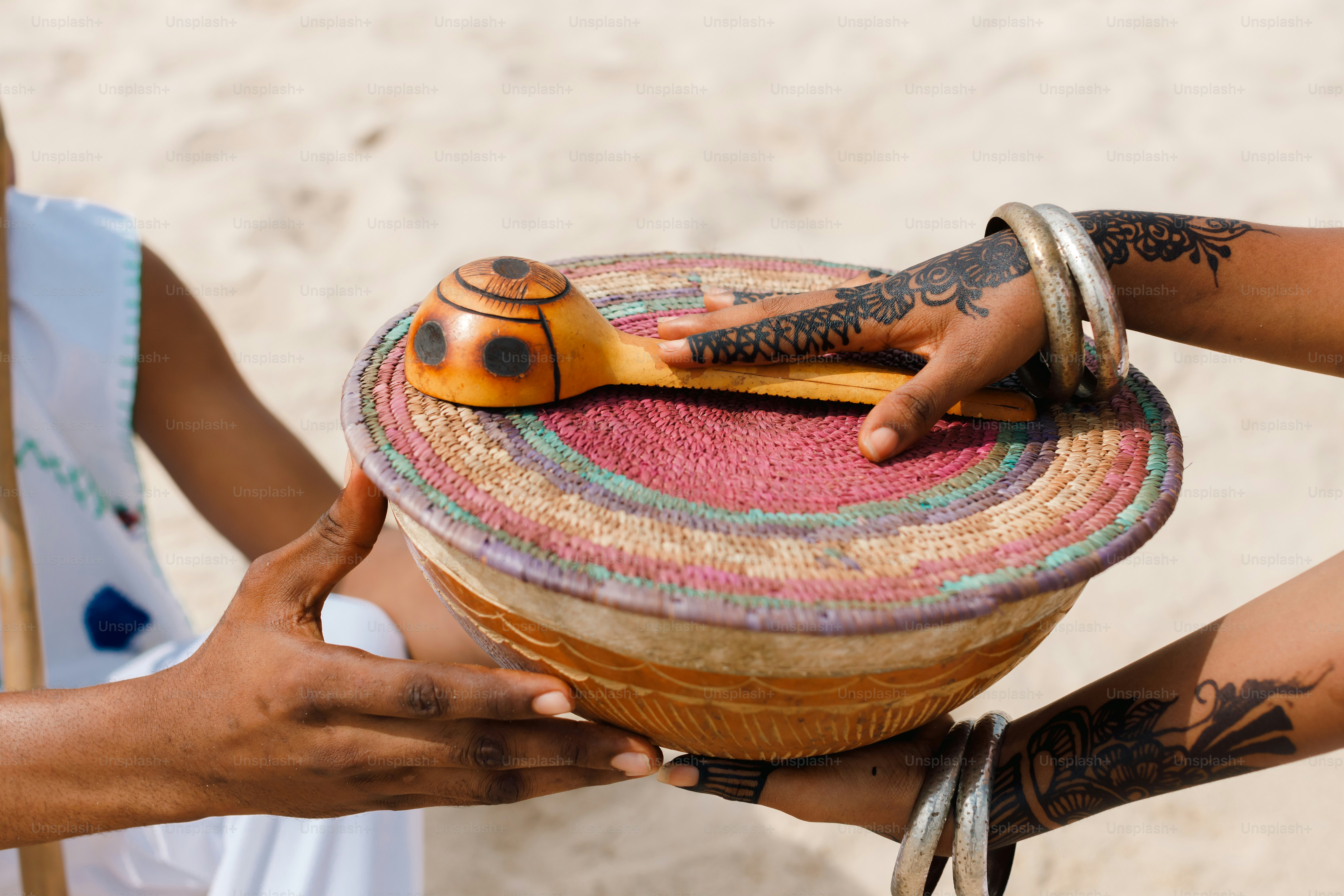 A woman is holding a basket with a snake on it