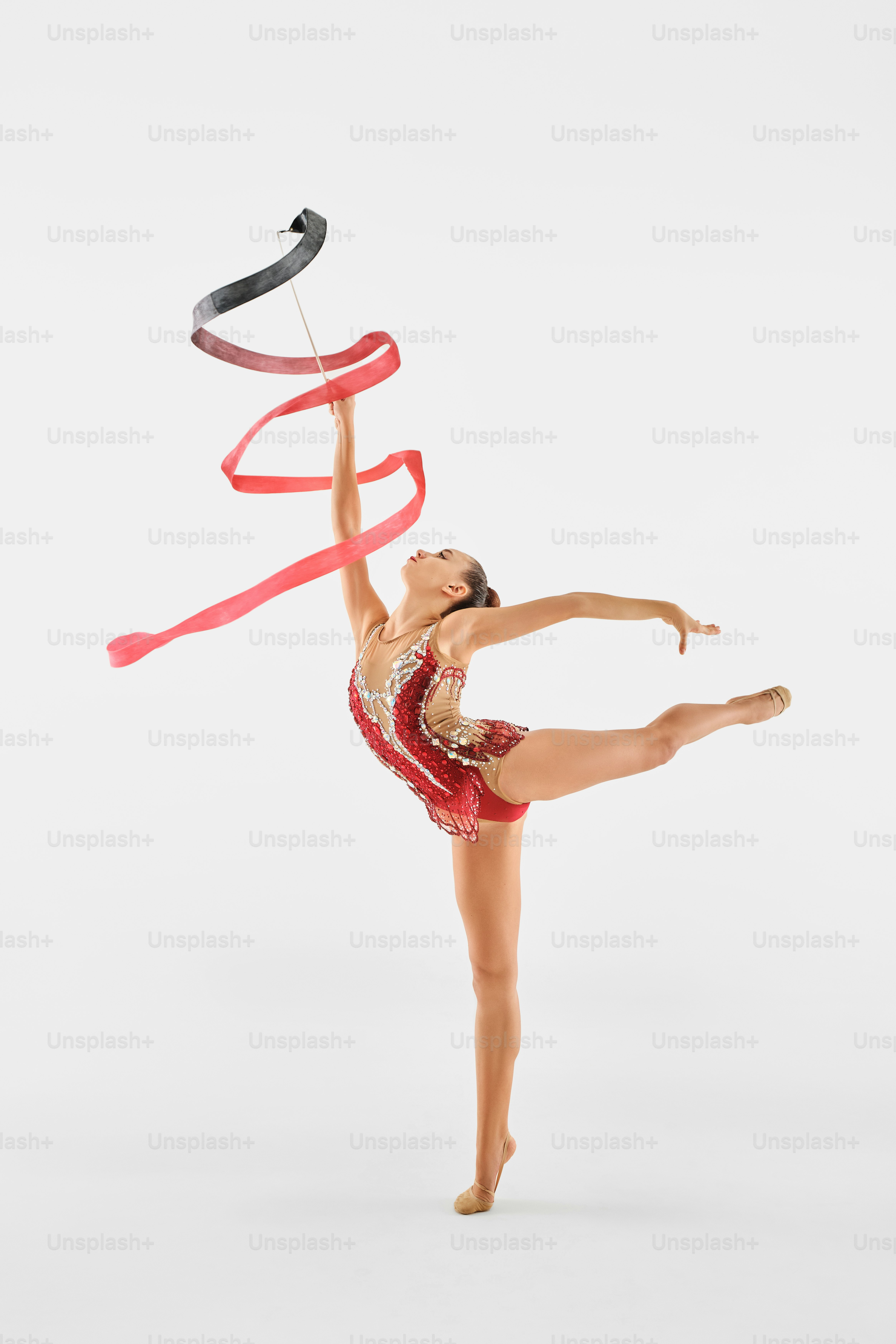 A woman is doing a trick with a ribbon