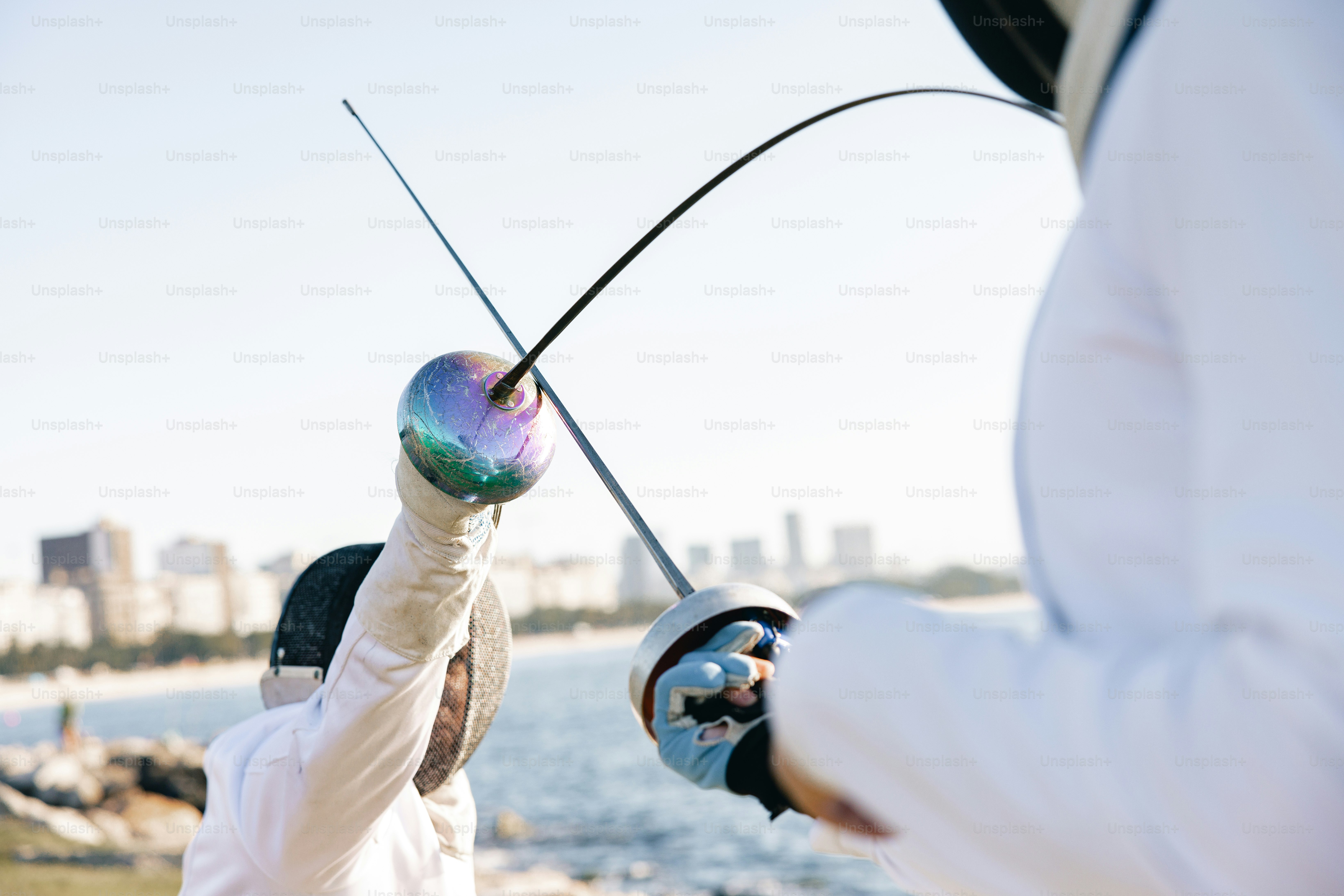 A man holding a fishing rod while another man holds a fishing rod