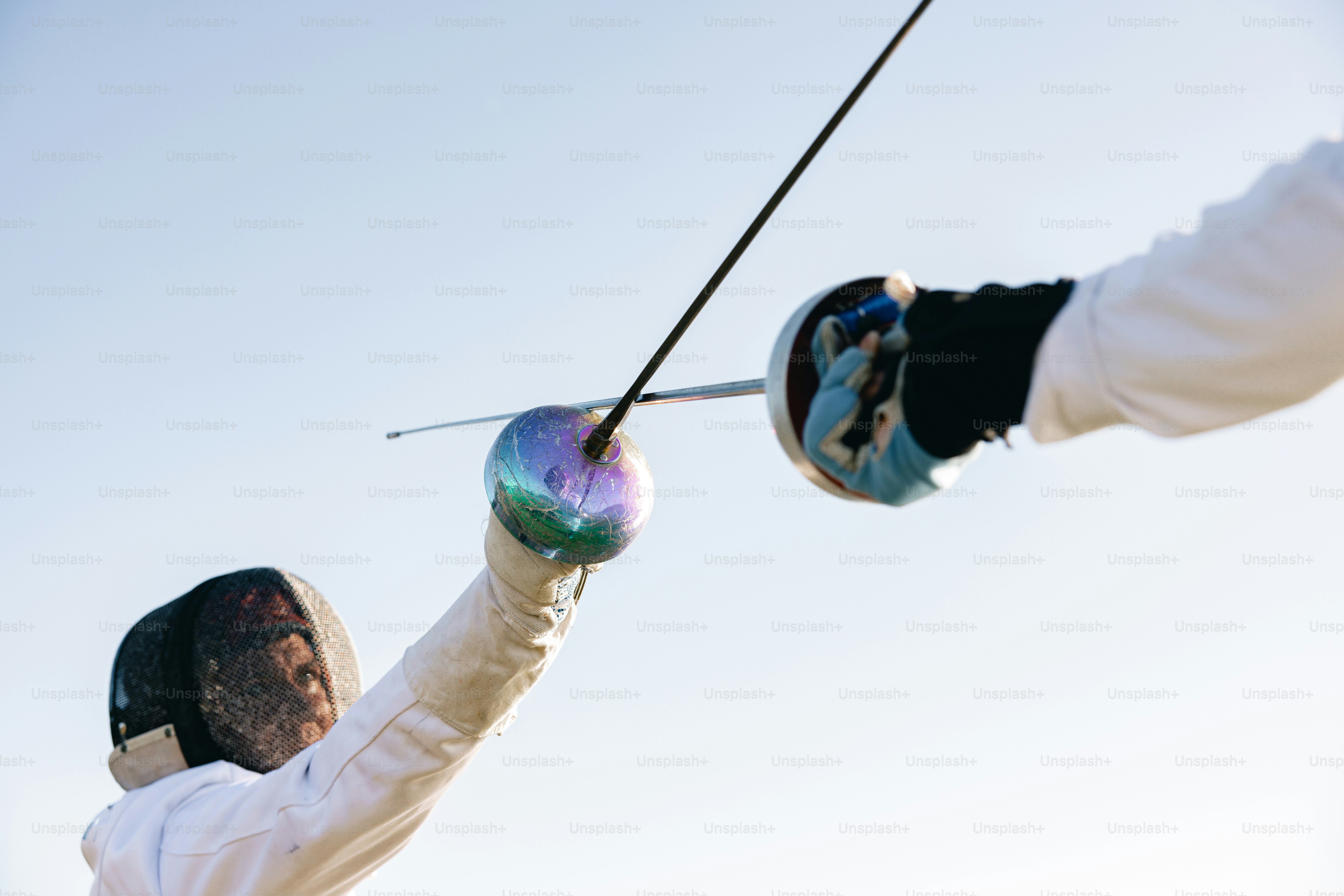 A man holding a pair of ski poles in the air