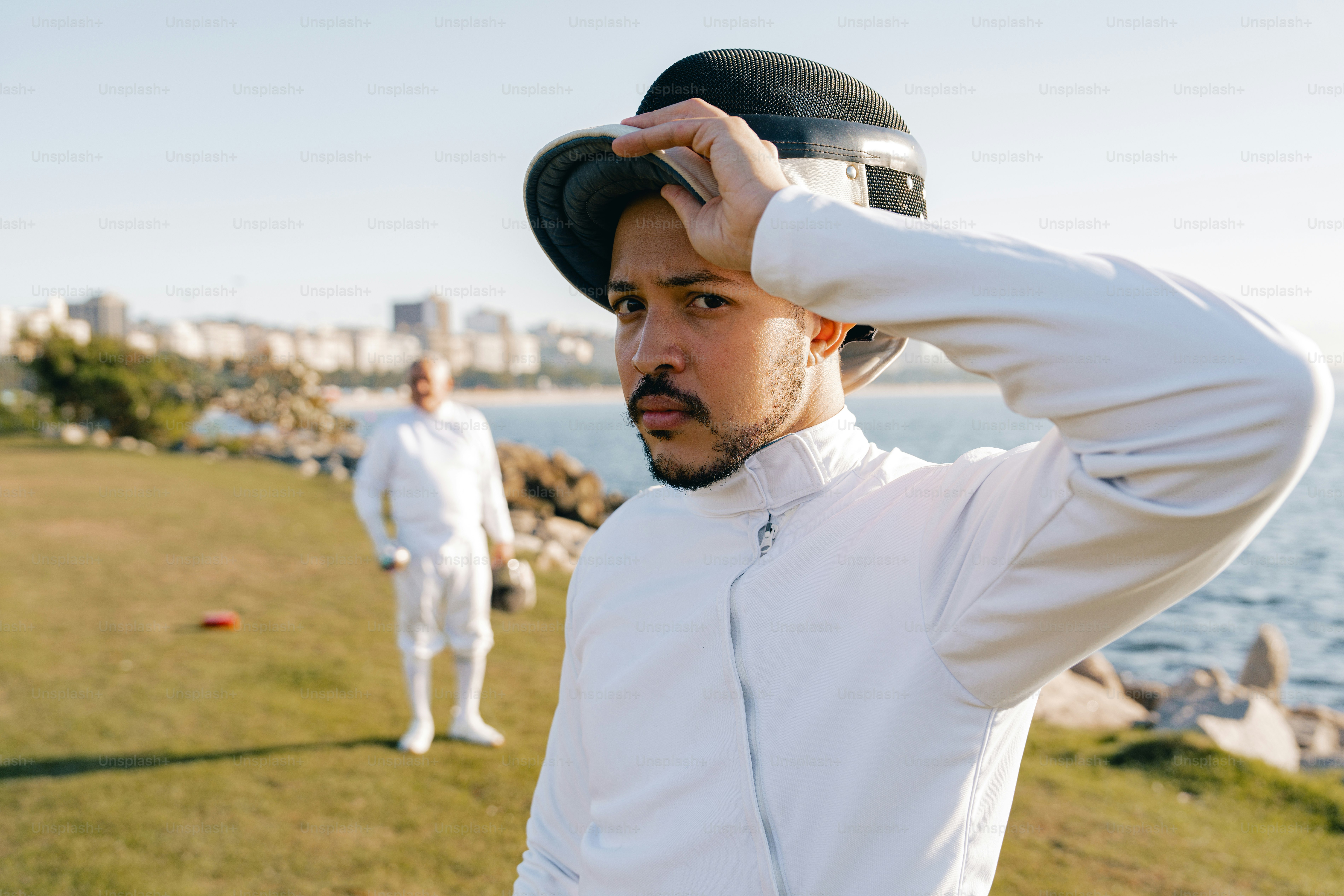 A man in a white jacket and a black hat