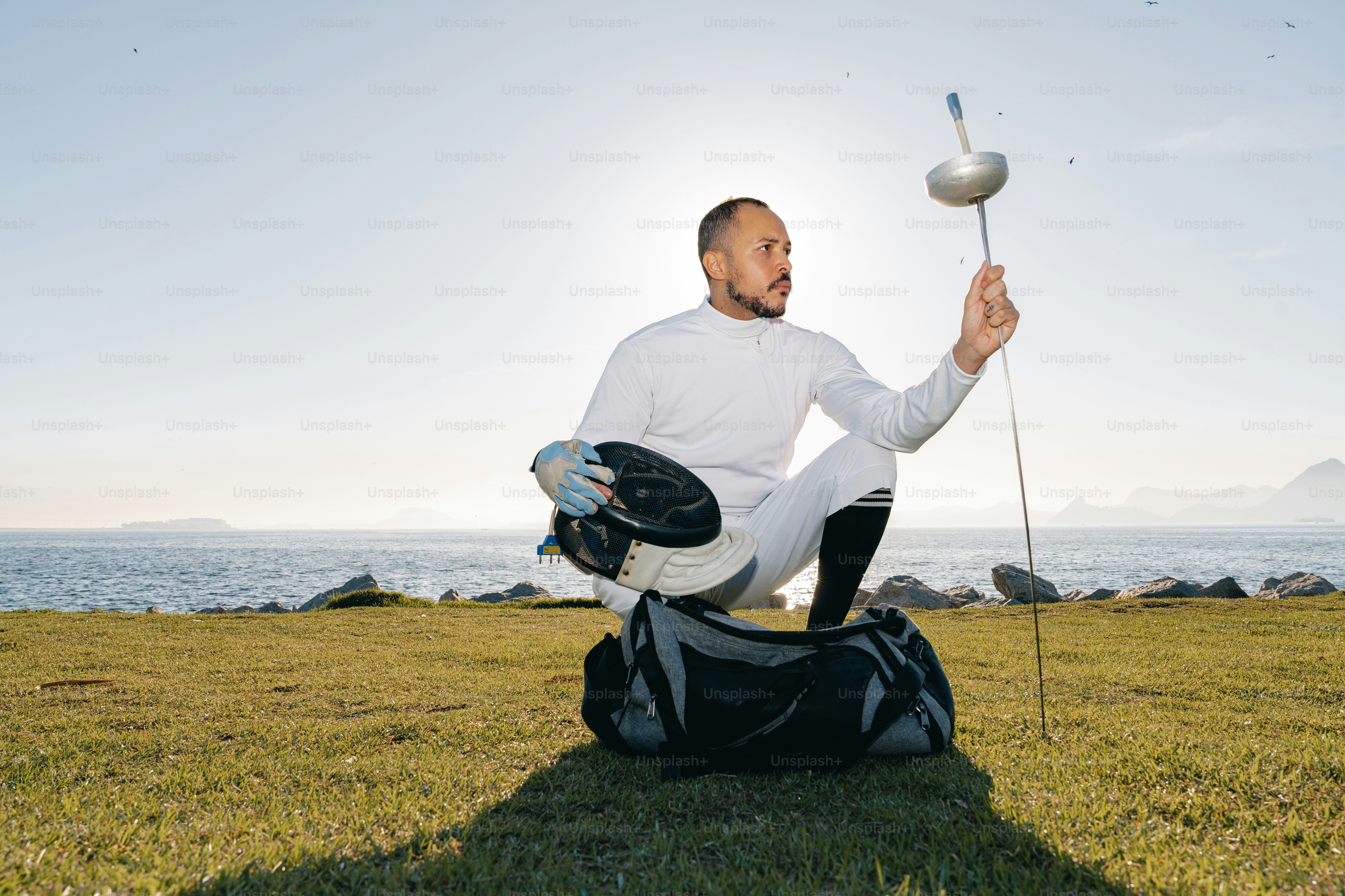 A man sitting on the ground holding a golf club