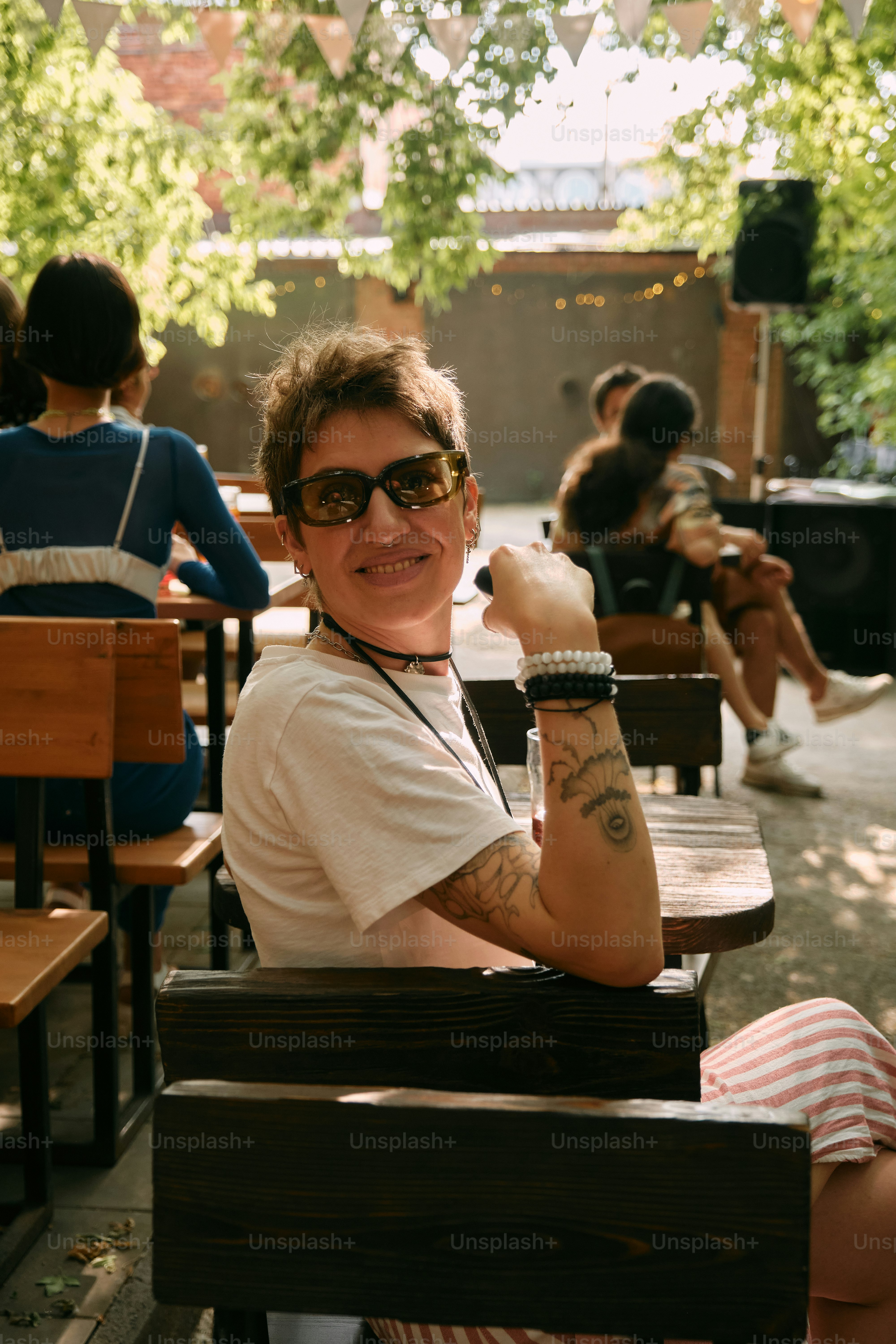 A woman sitting at a table with her arms crossed