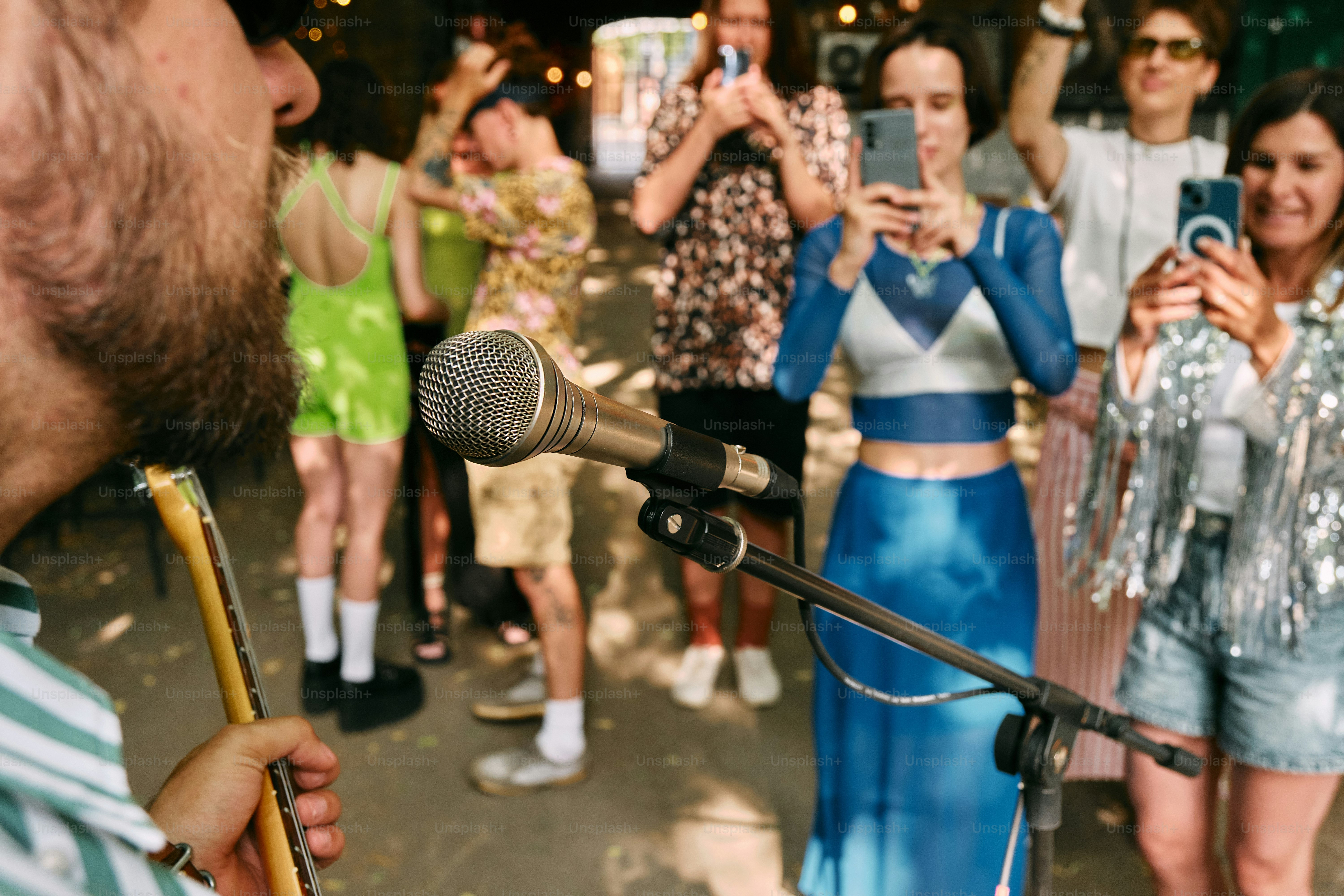 A group of people standing around a microphone
