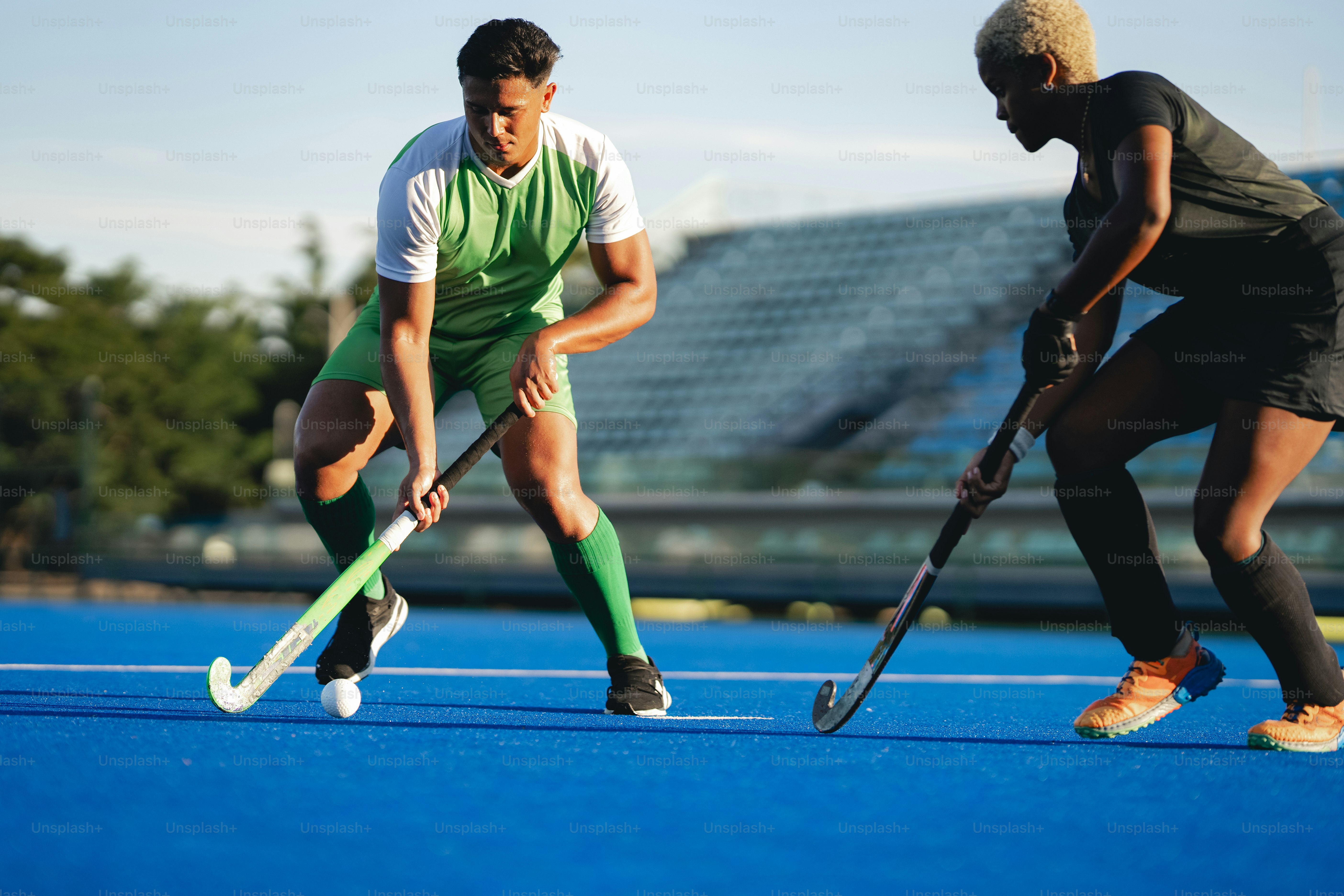 A couple of men standing on top of a blue field