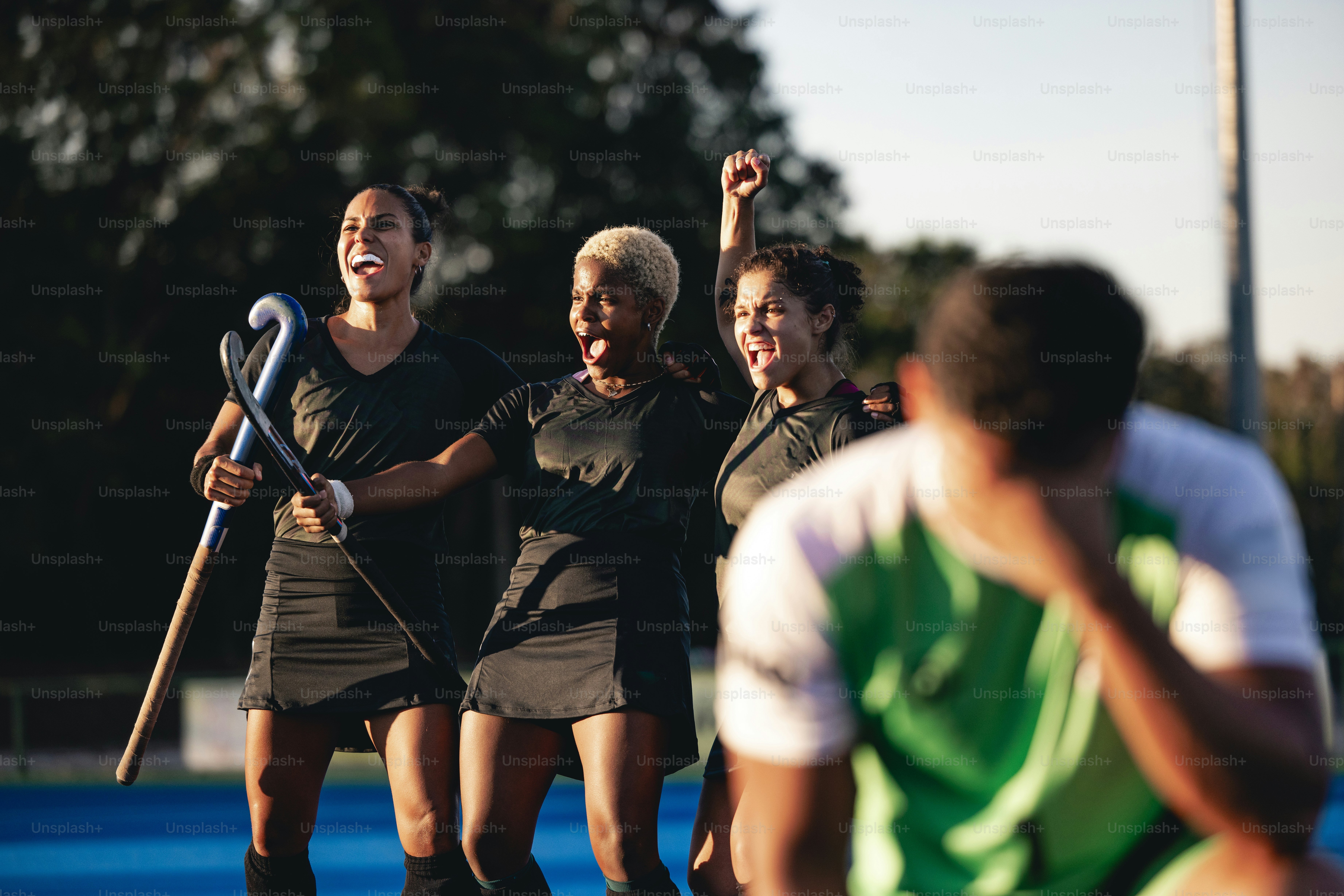 A group of women standing on top of a tennis court