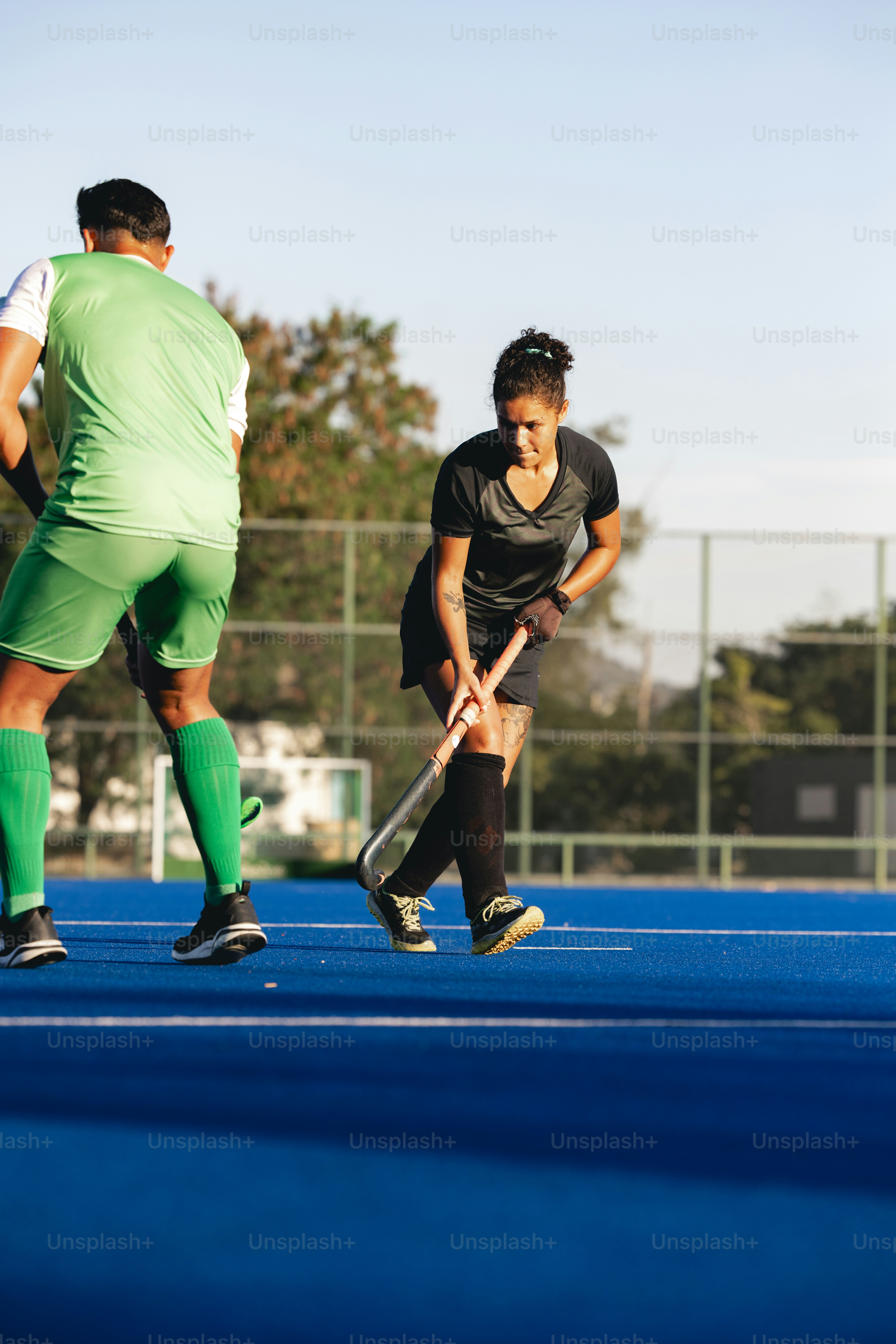 A group of men playing a game of field hockey