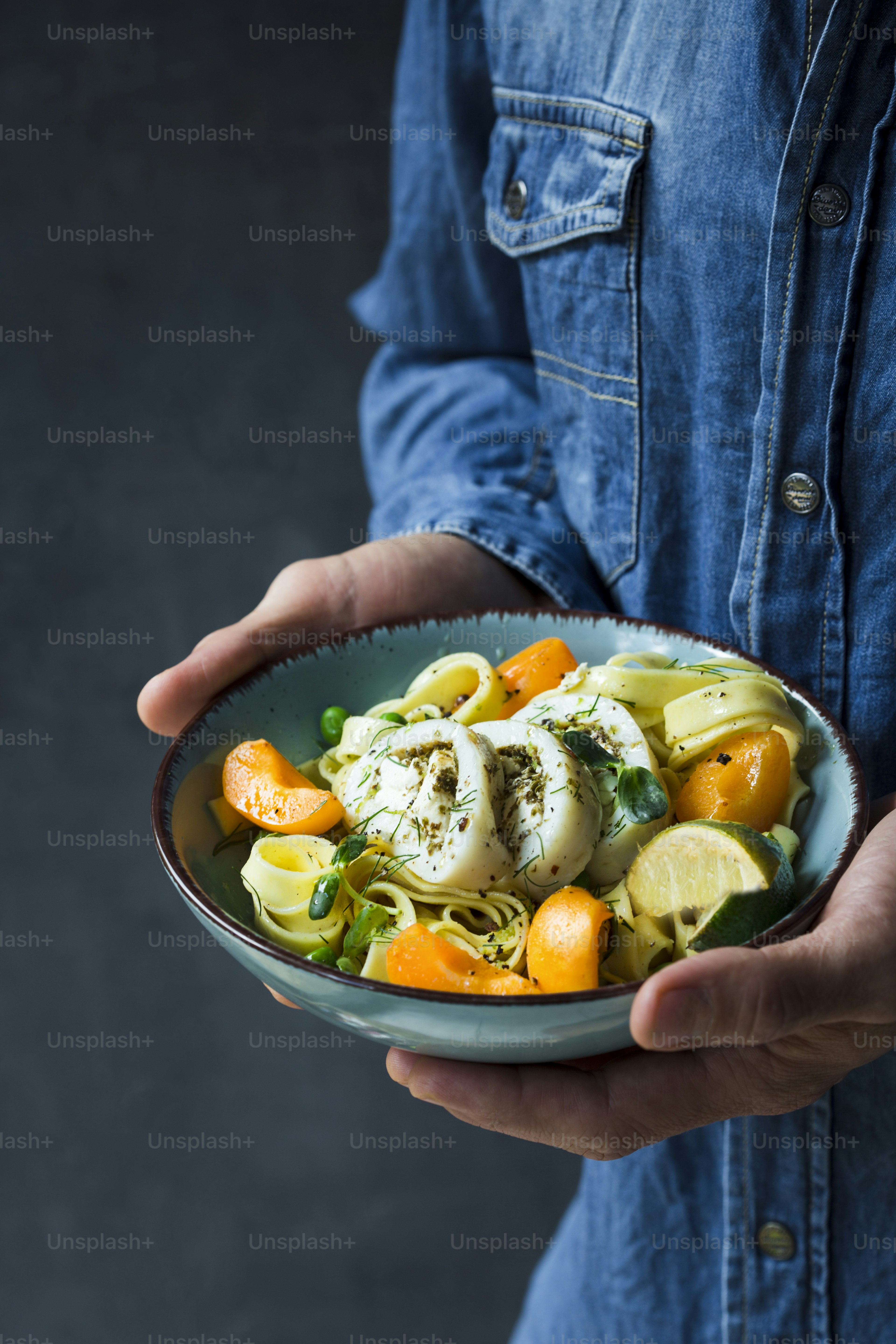 A man is holding a bowl of food