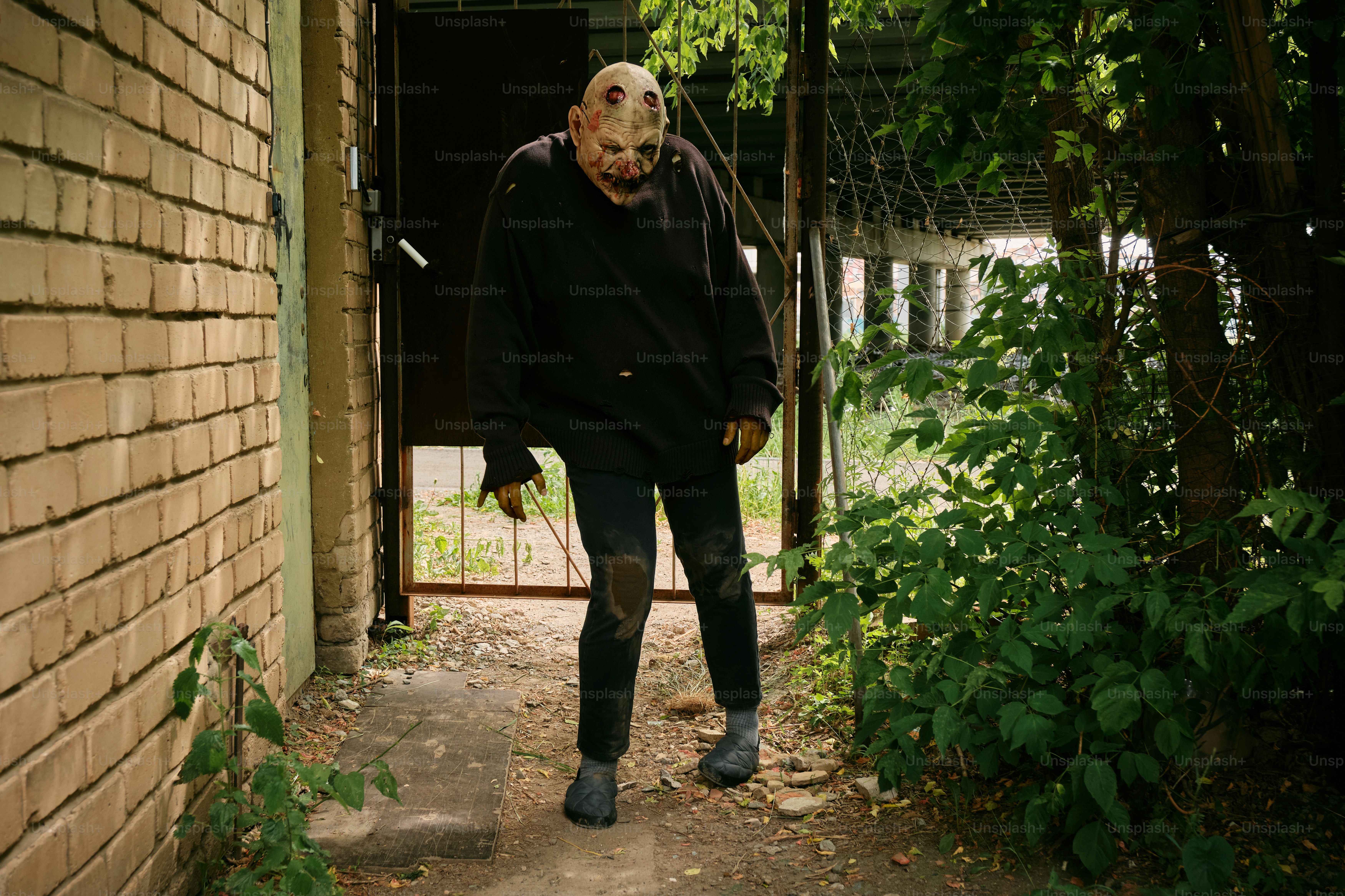 A person with a mask walking down a path