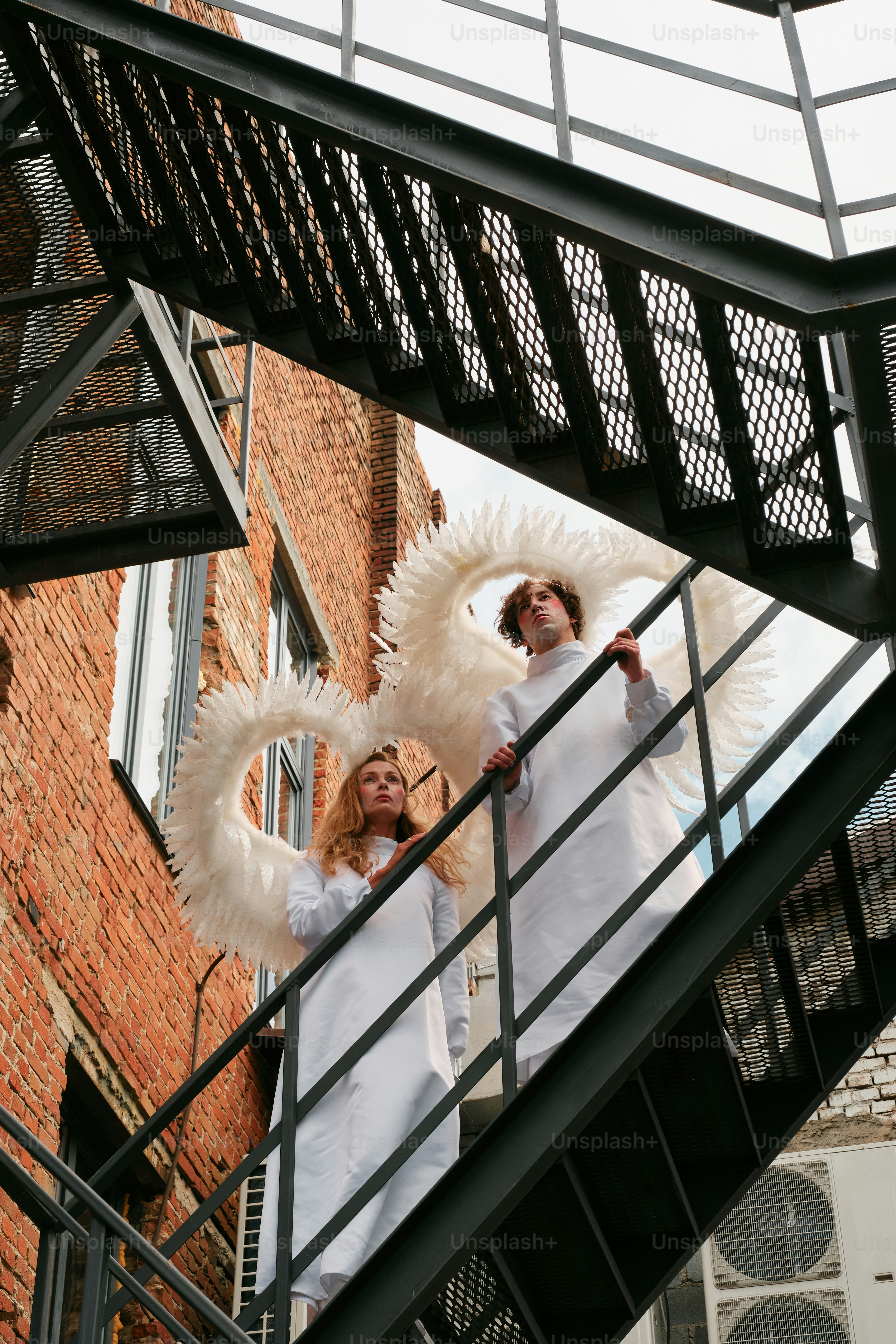 A couple of women standing on top of a stair case
