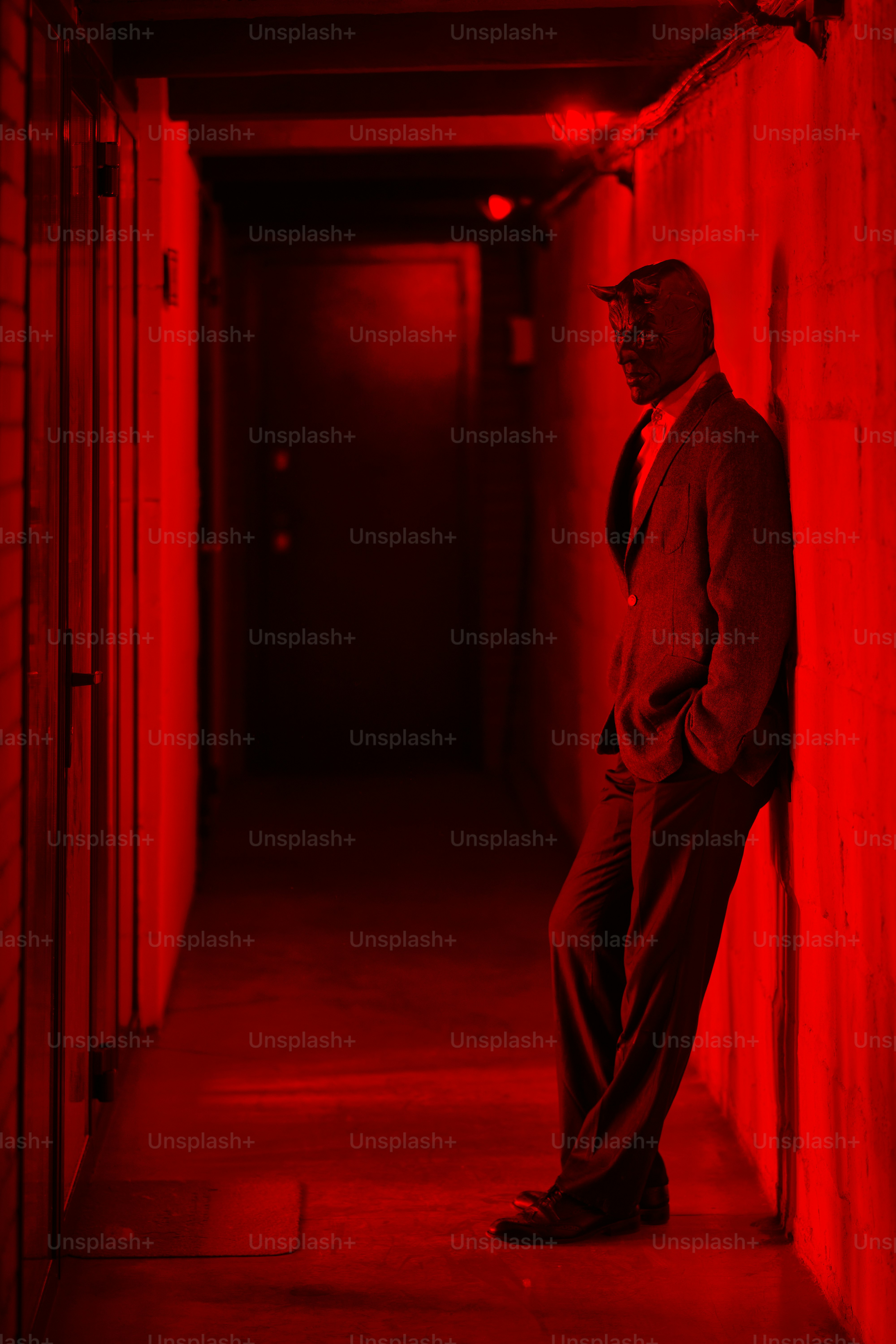 A man in a suit and tie standing in a hallway