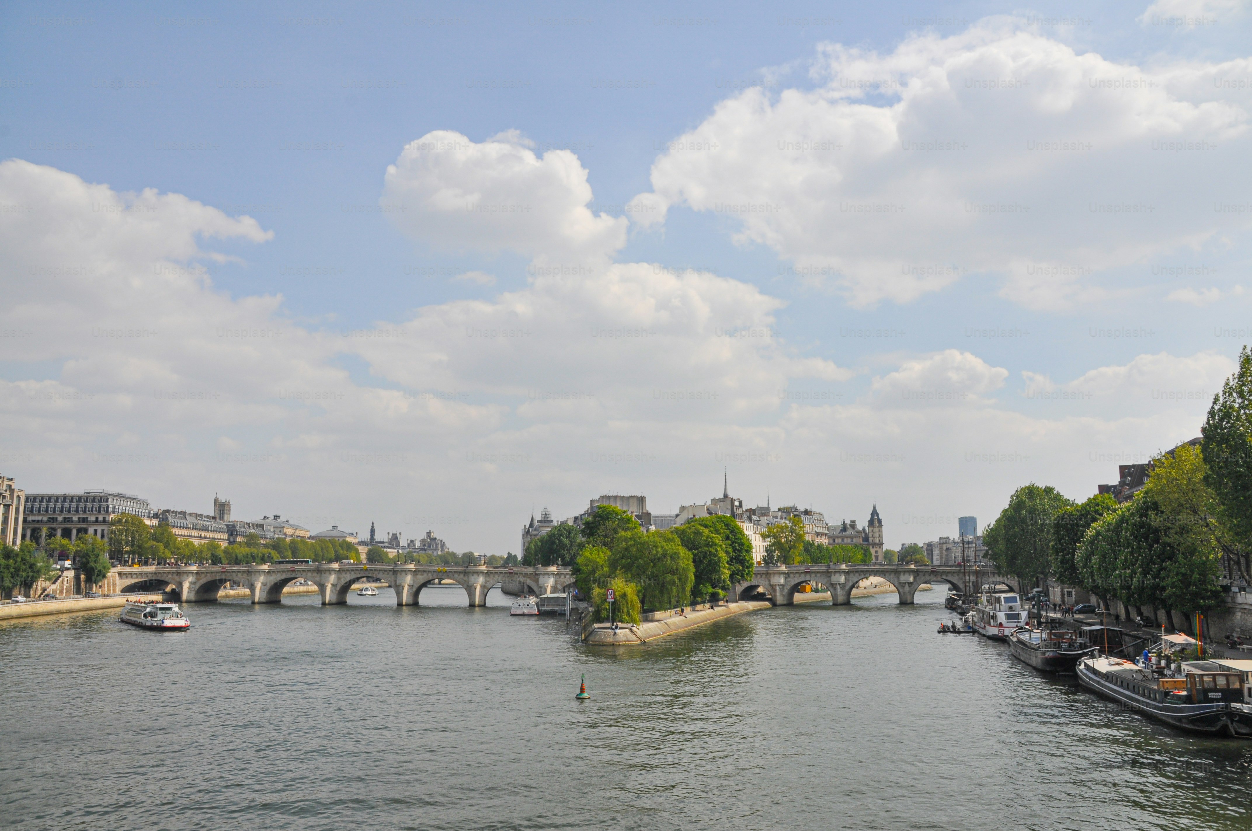 A river with boats on it and a bridge in the background