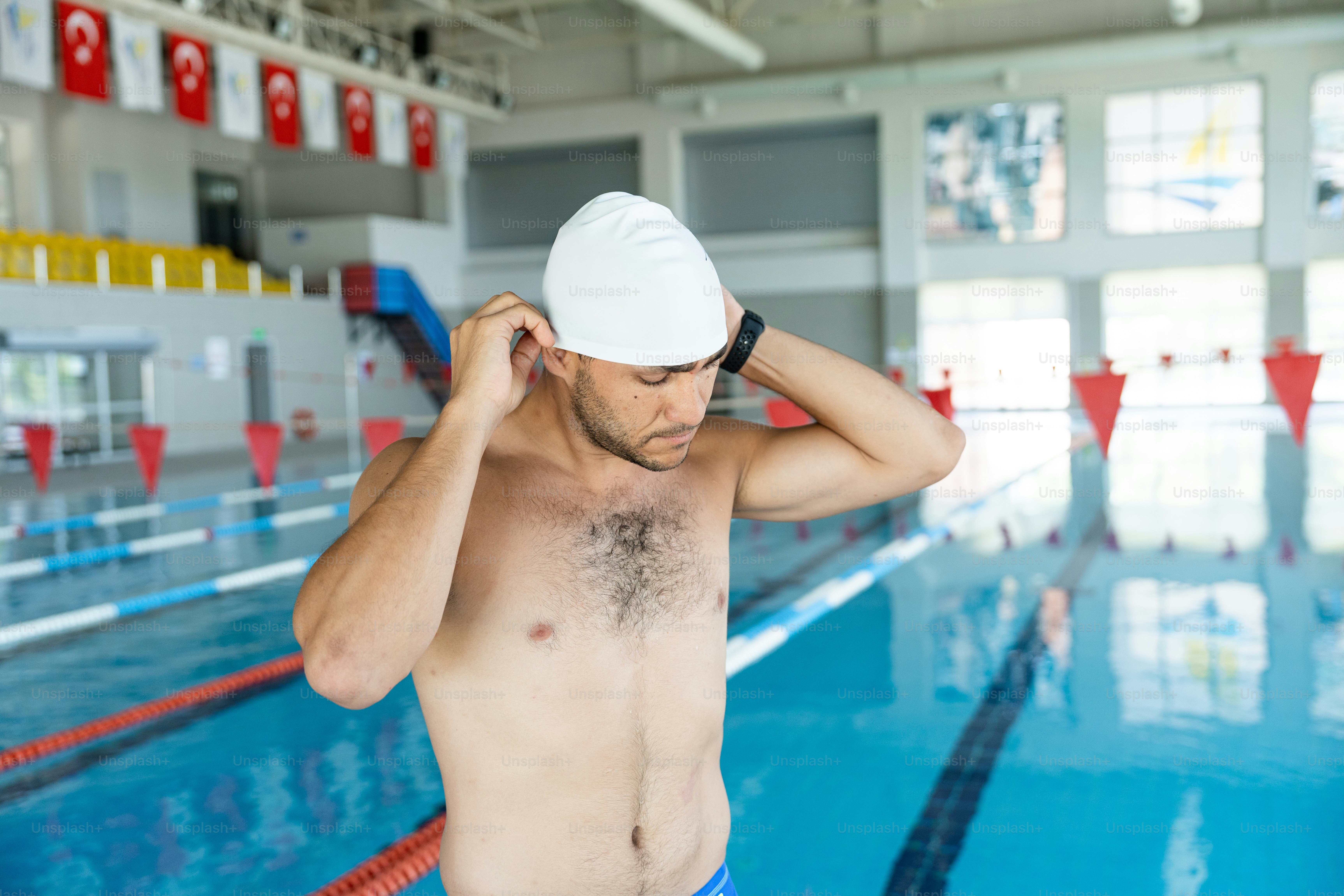 A man in a swimming pool with no shirt on