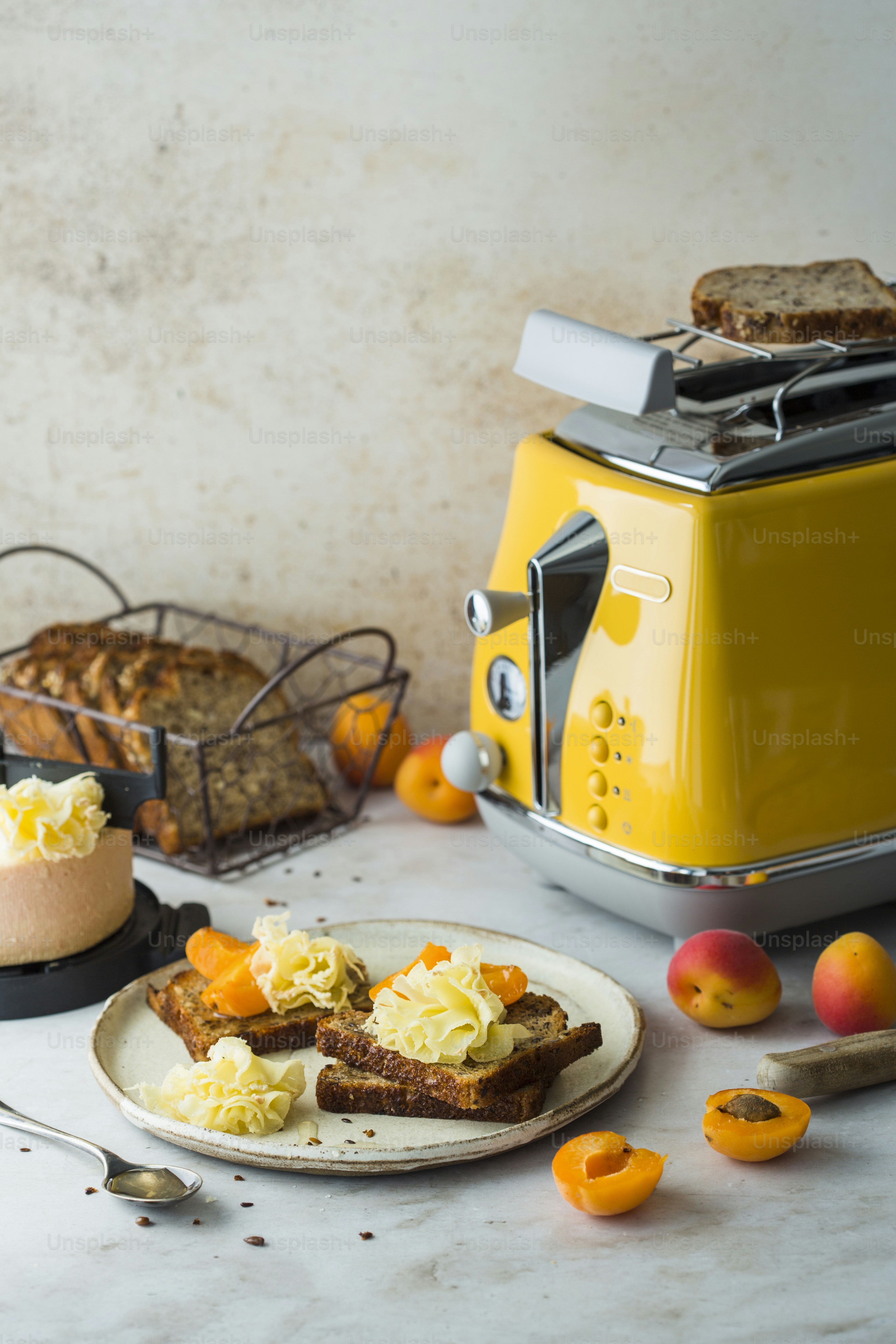 A toaster and a plate of food on a table