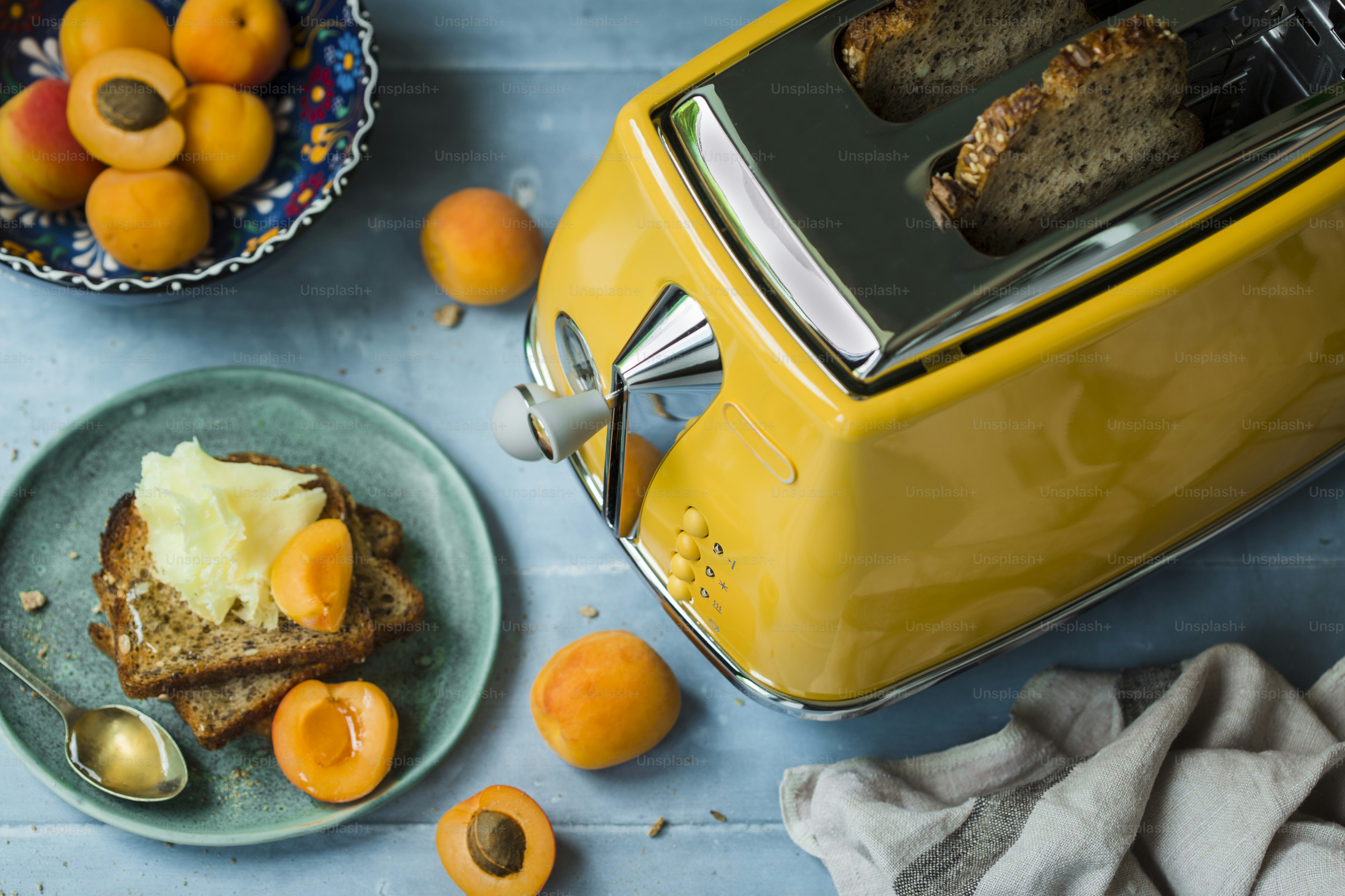 A yellow toaster oven sitting on top of a blue counter