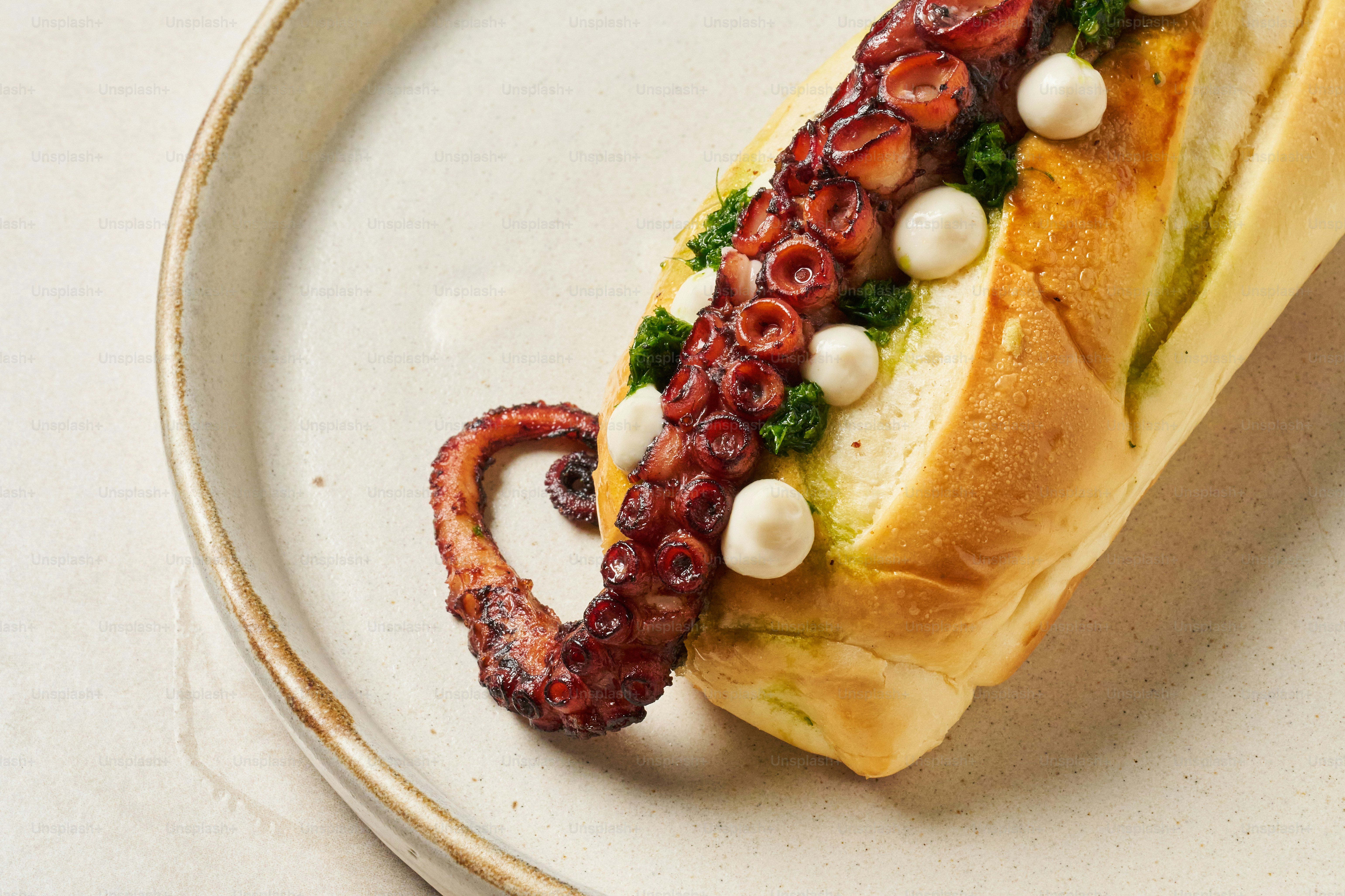 A plate with a sandwich on it with an octopus on it