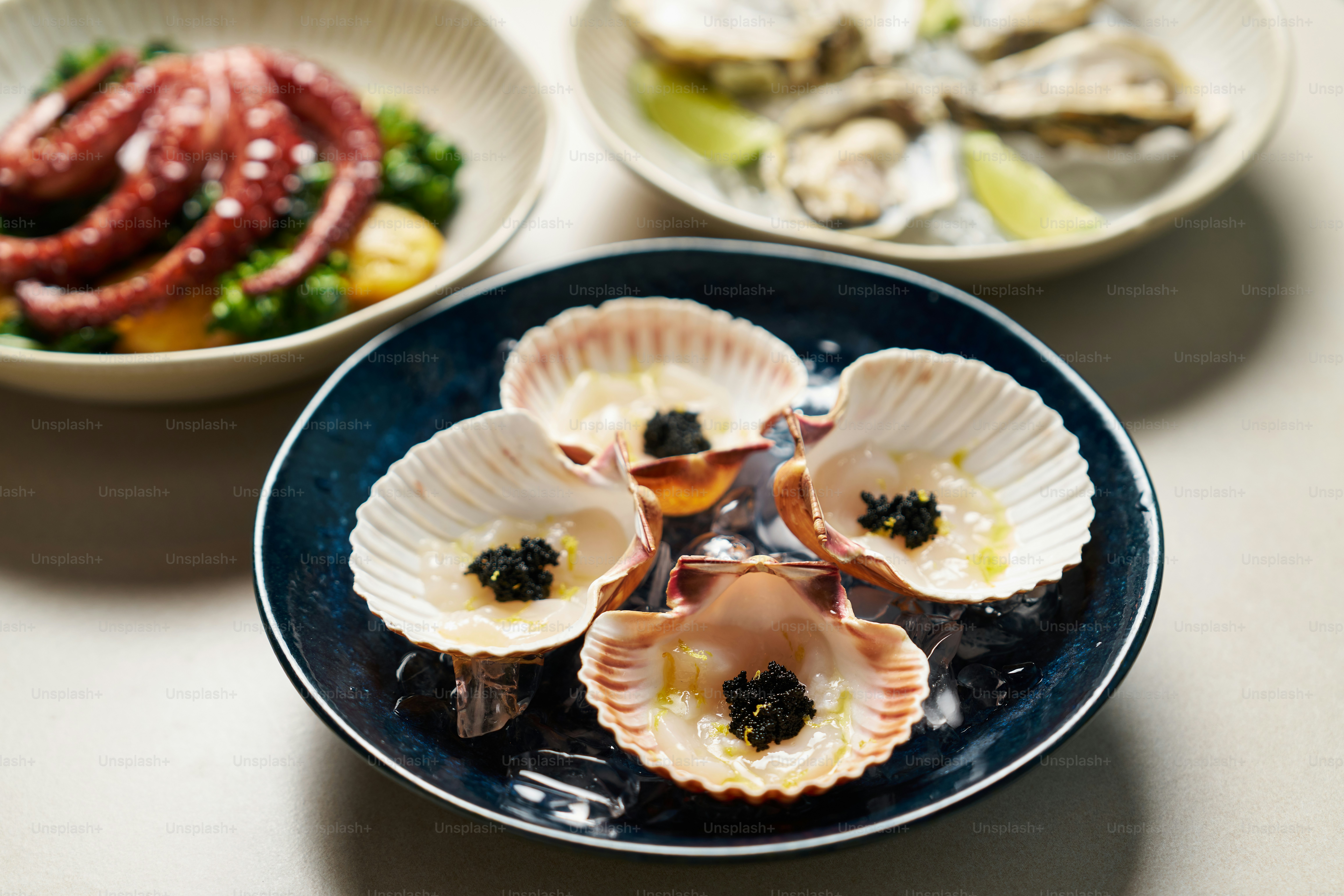 A table topped with plates of food and bowls of food