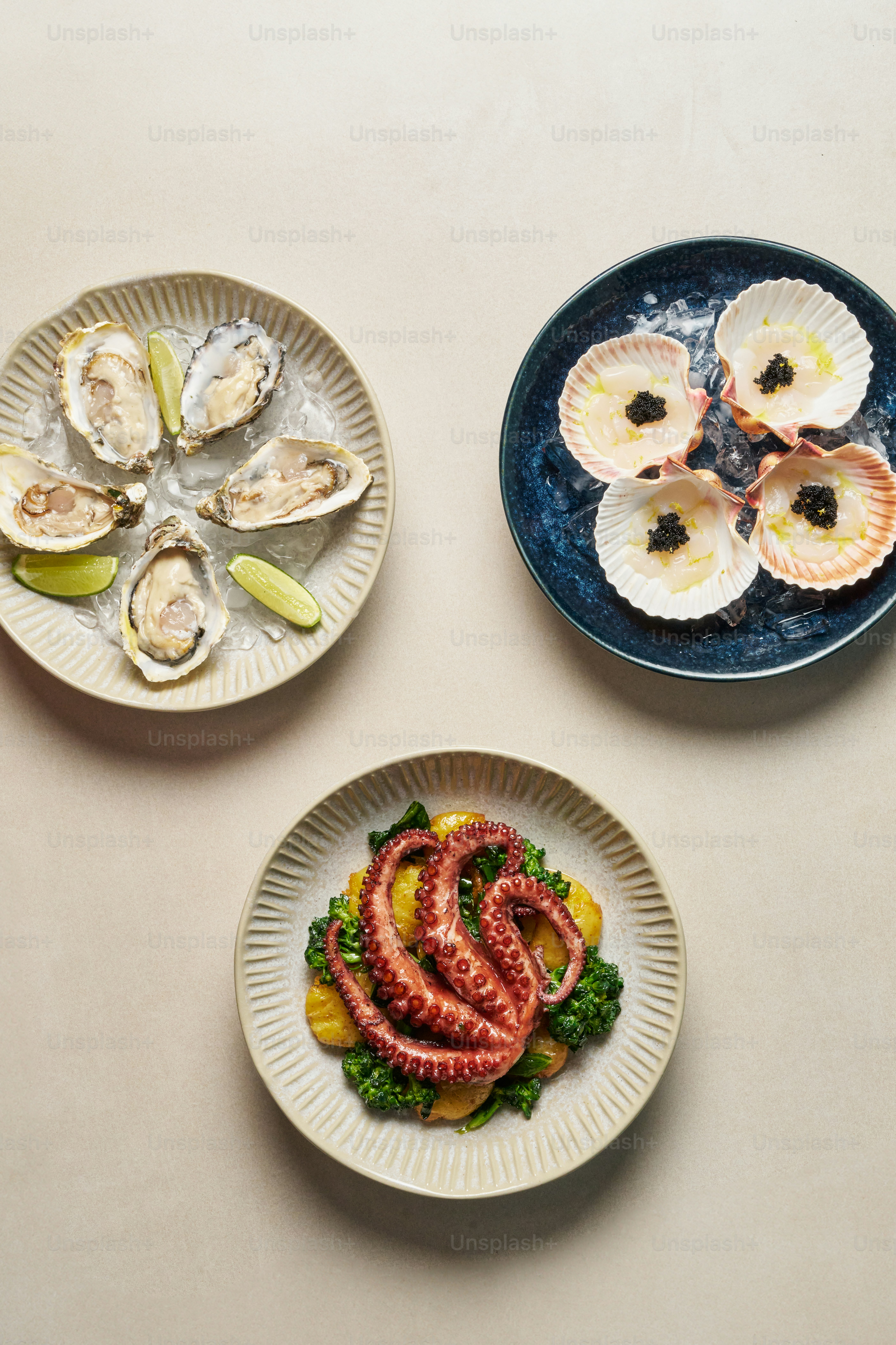 Three plates of food are arranged on a table