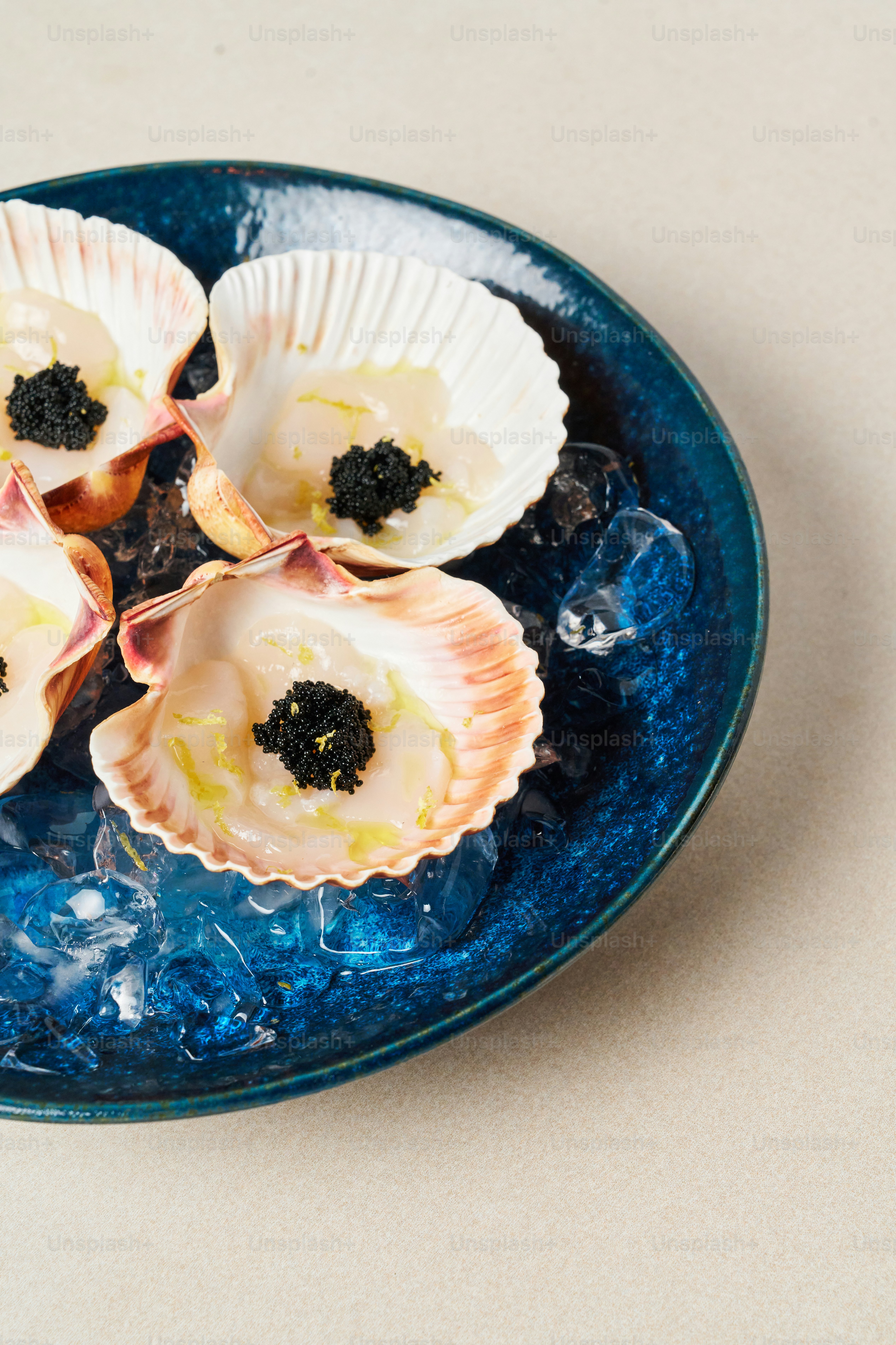 A blue bowl filled with seashells on top of a table