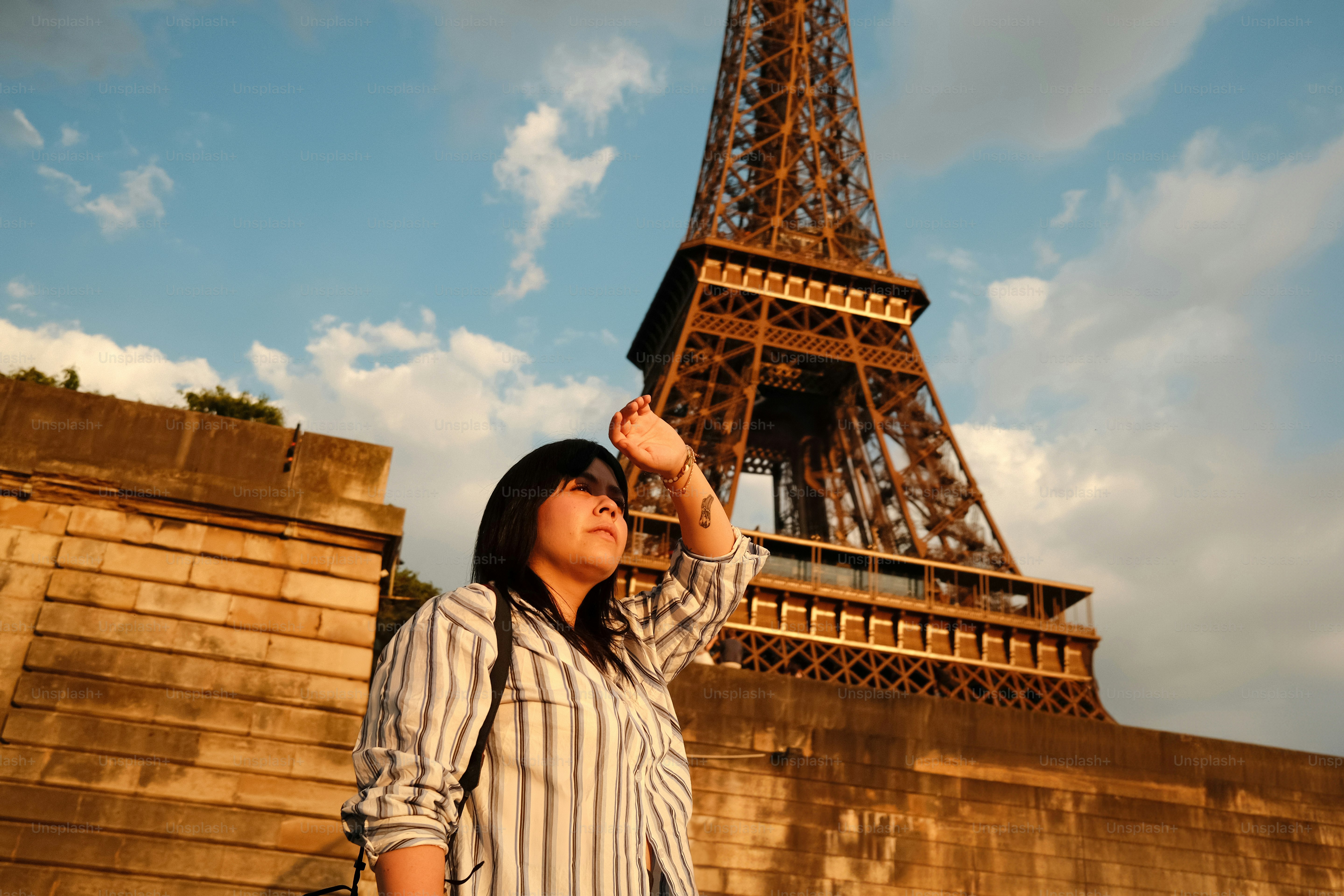 A woman standing in front of the eiffel tower