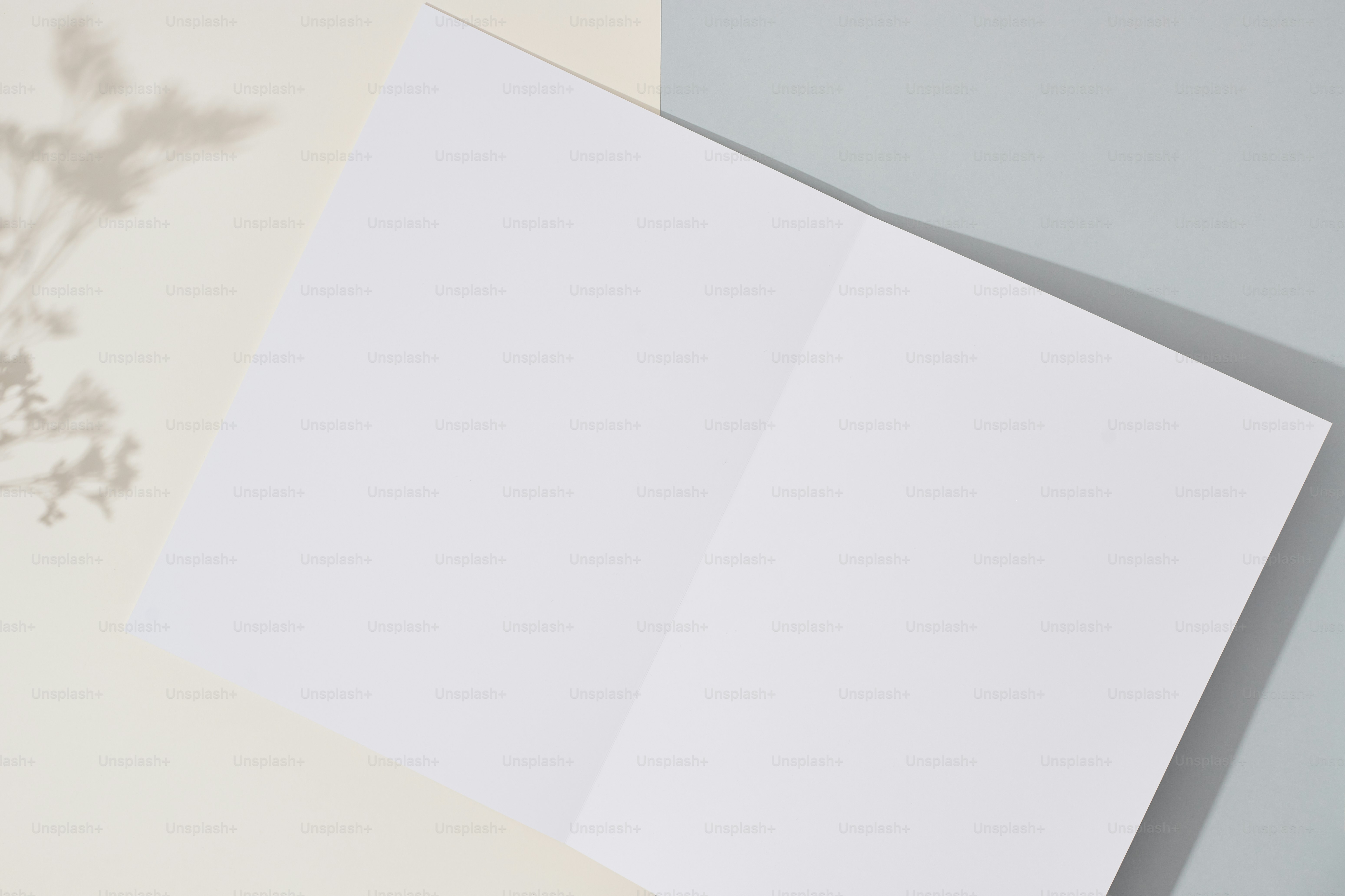 An open book on a table next to a vase of flowers