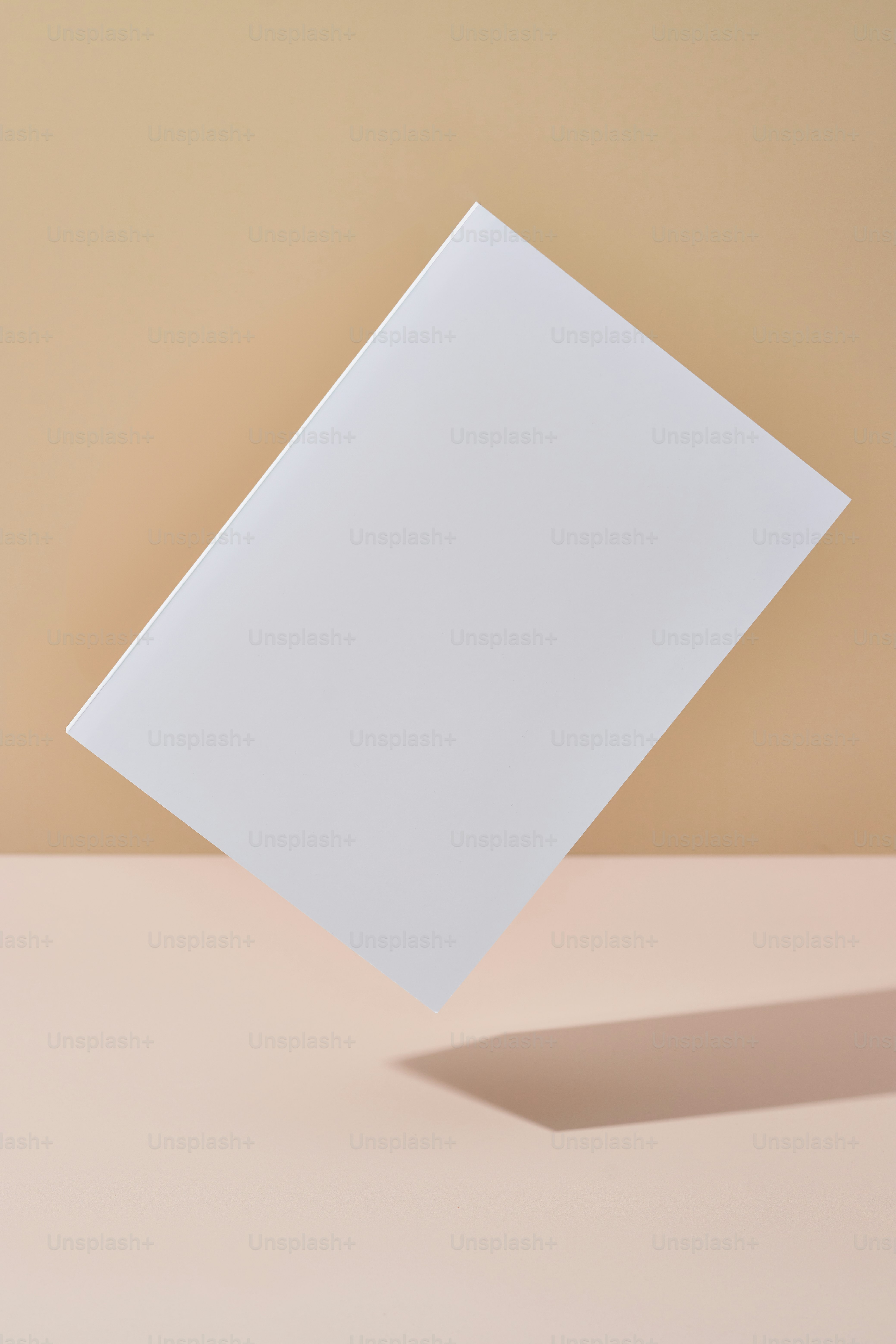 A white square object on a pink surface