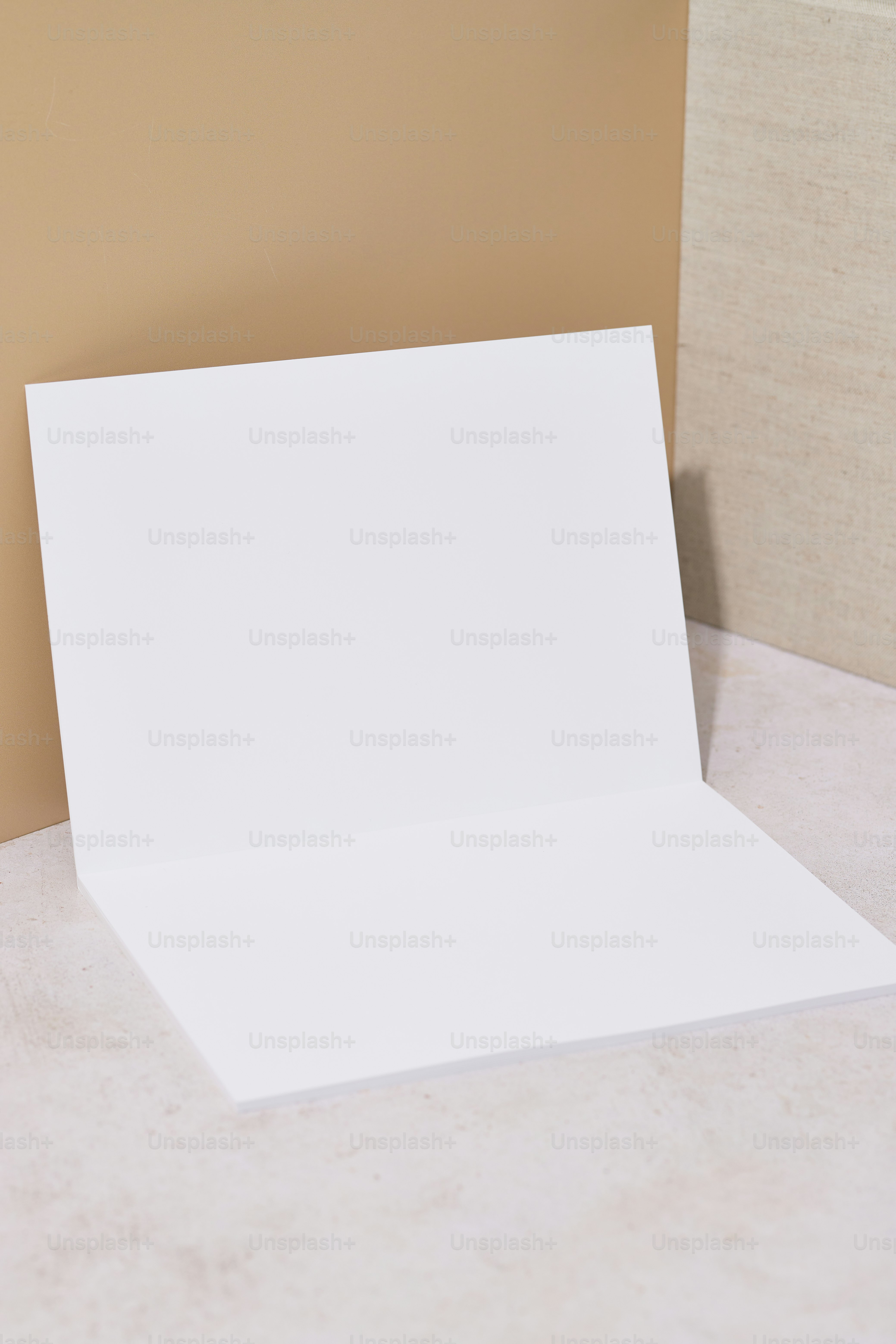 An empty white card on a table next to a wall