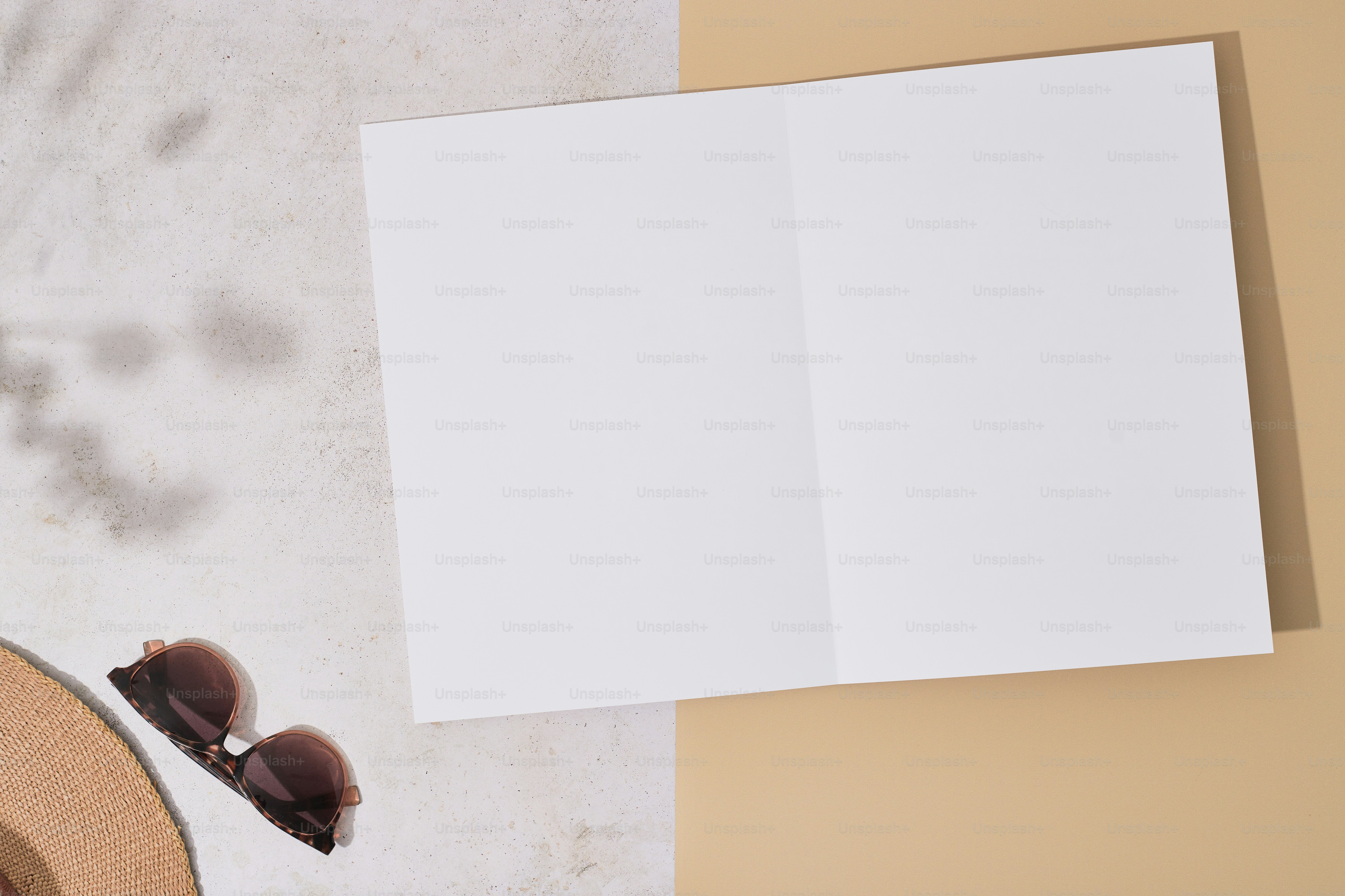 Overhead of magazine mockup with a hat and sunglasses.