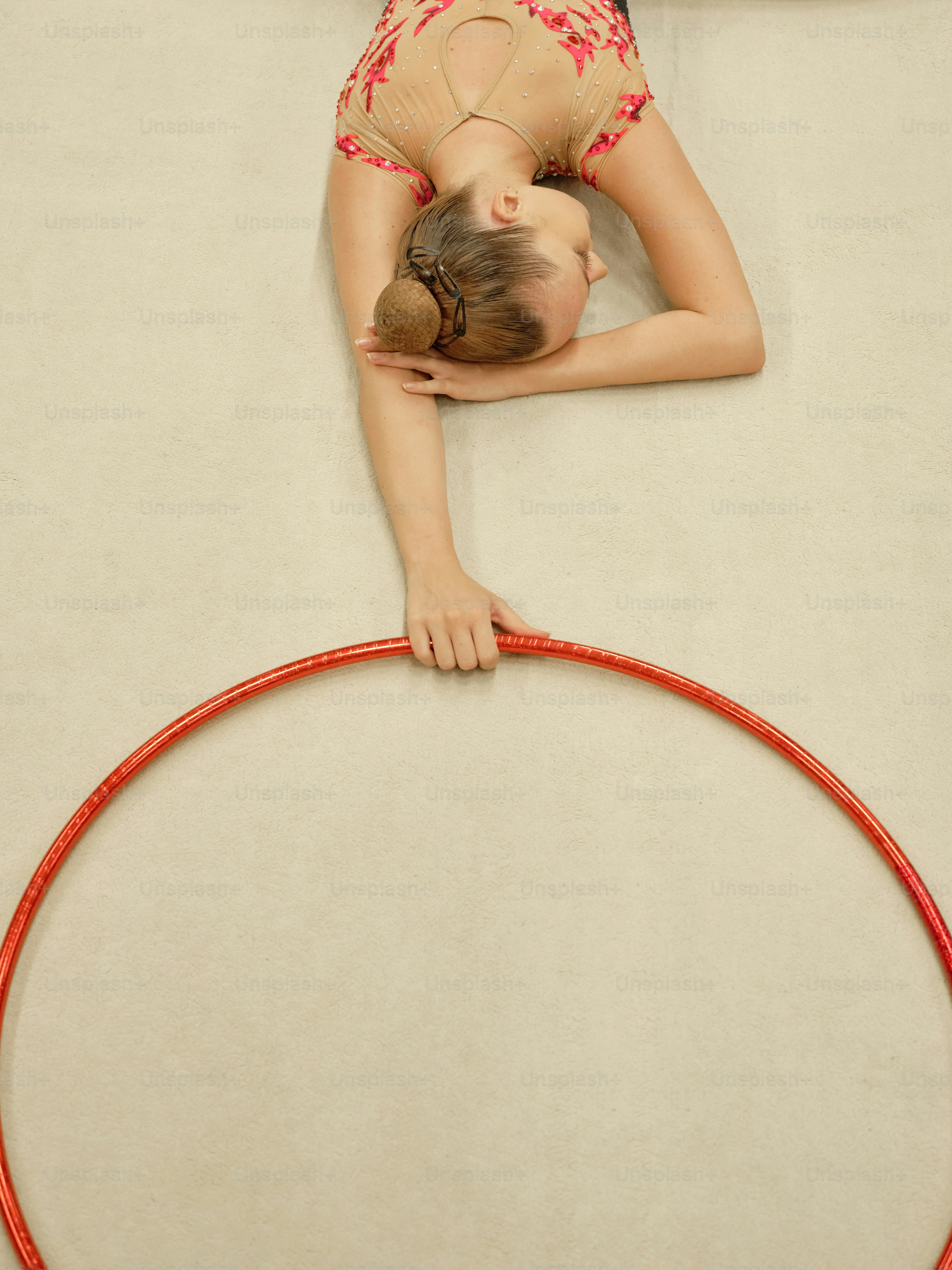 A young girl is doing a trick on a hoop