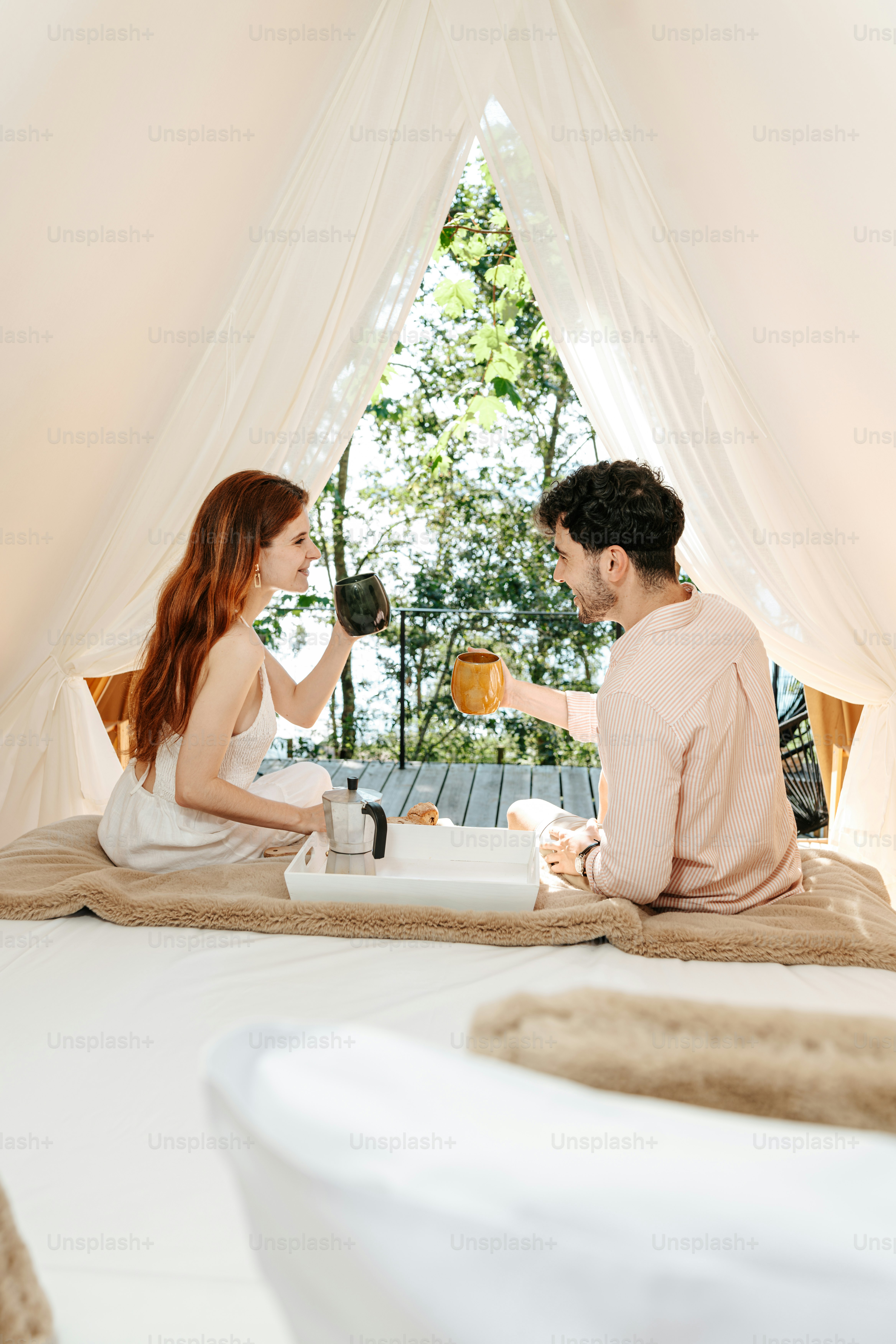 テントのベッドに座る男女