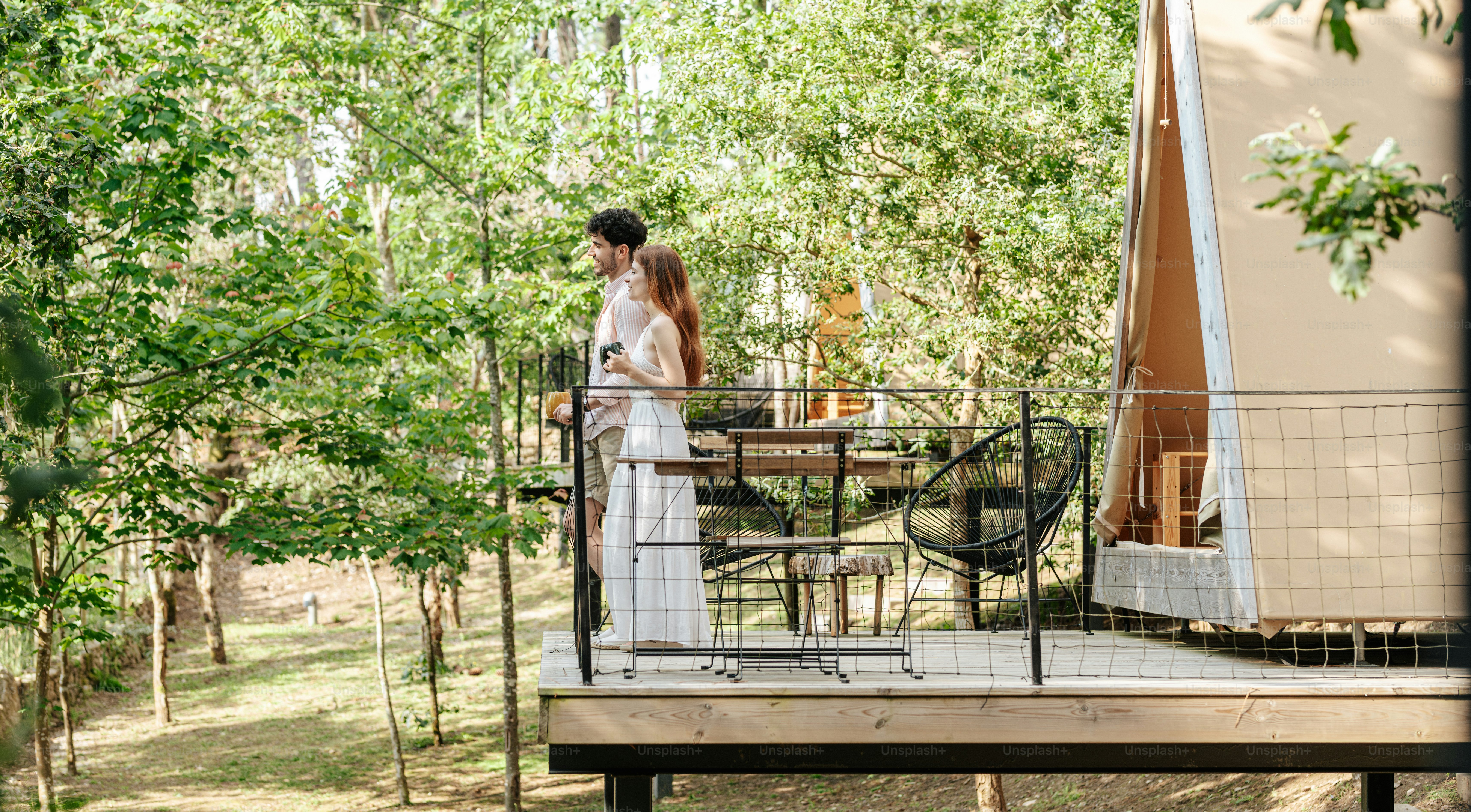 A woman standing on a deck in the woods