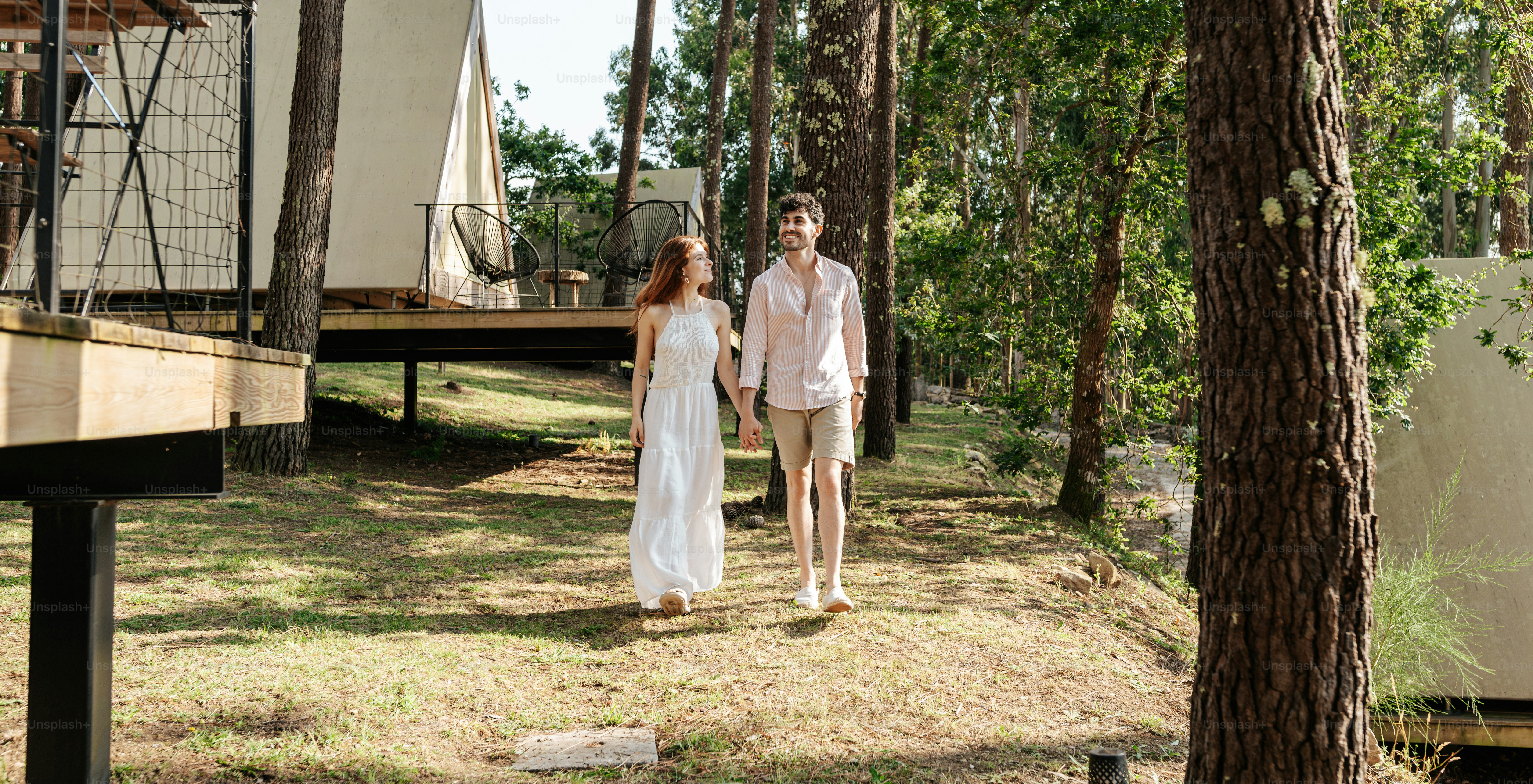 A man and a woman walking through the woods
