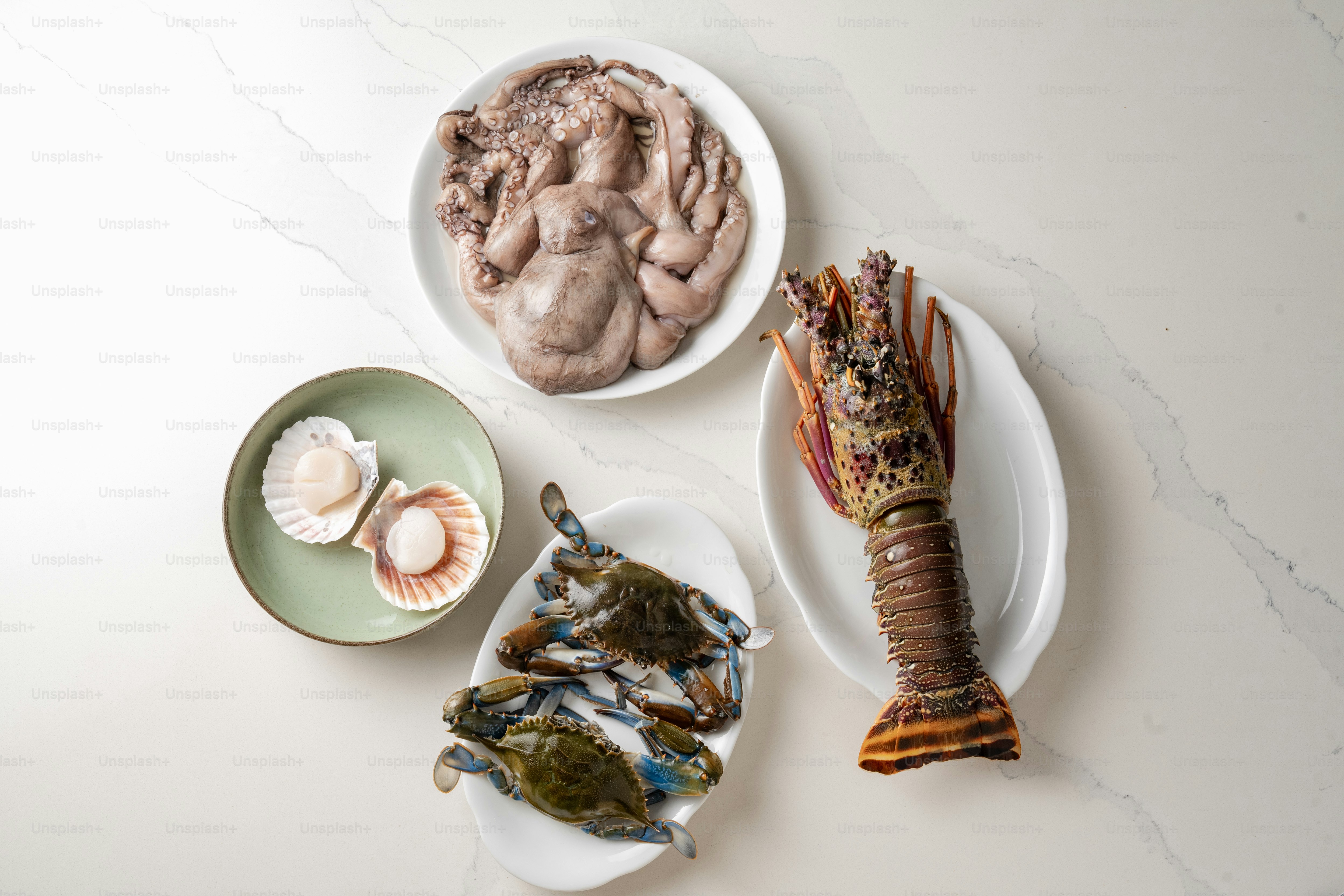 Three plates of food on a white table