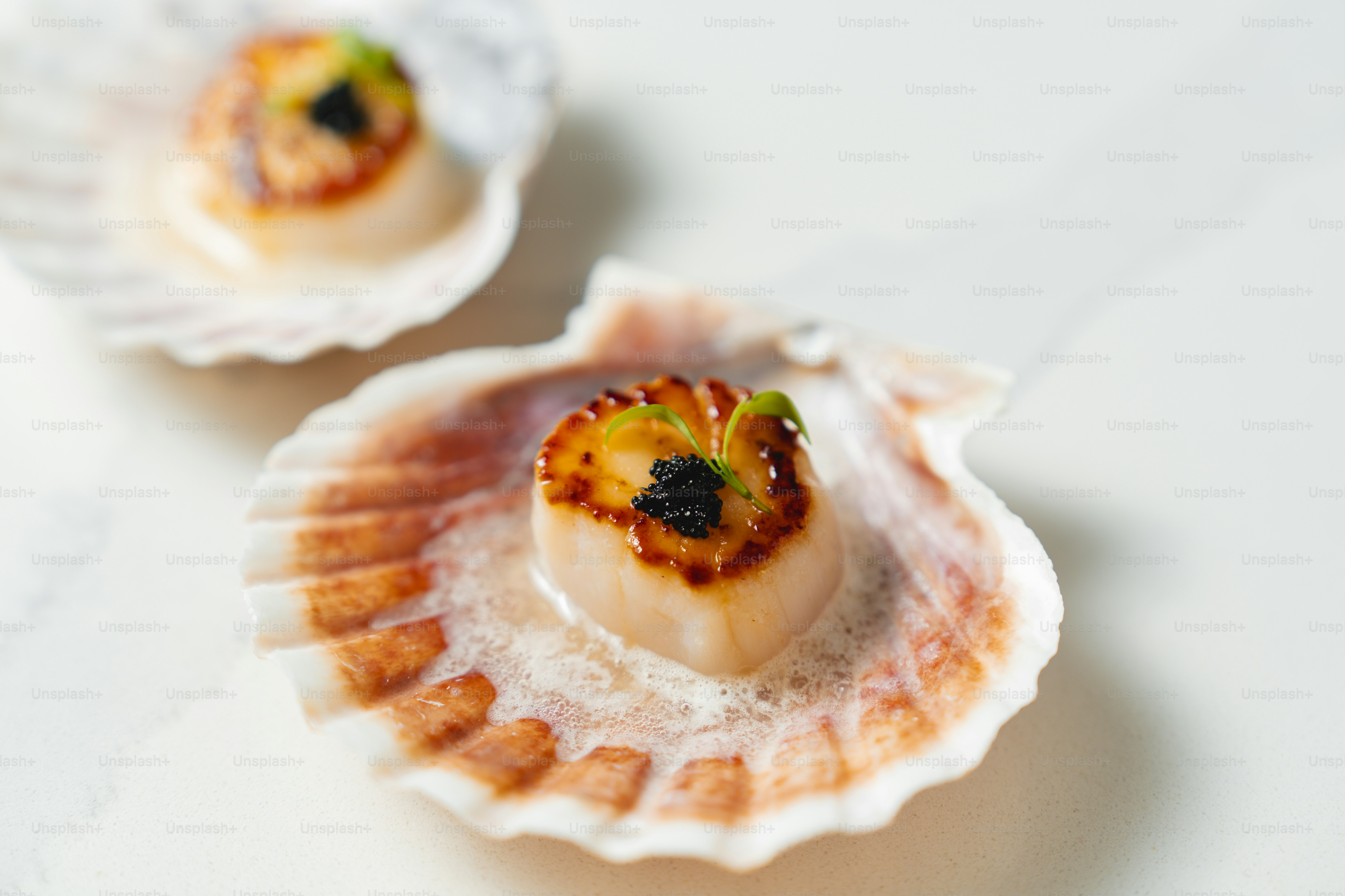A close up of two scallop shells on a table