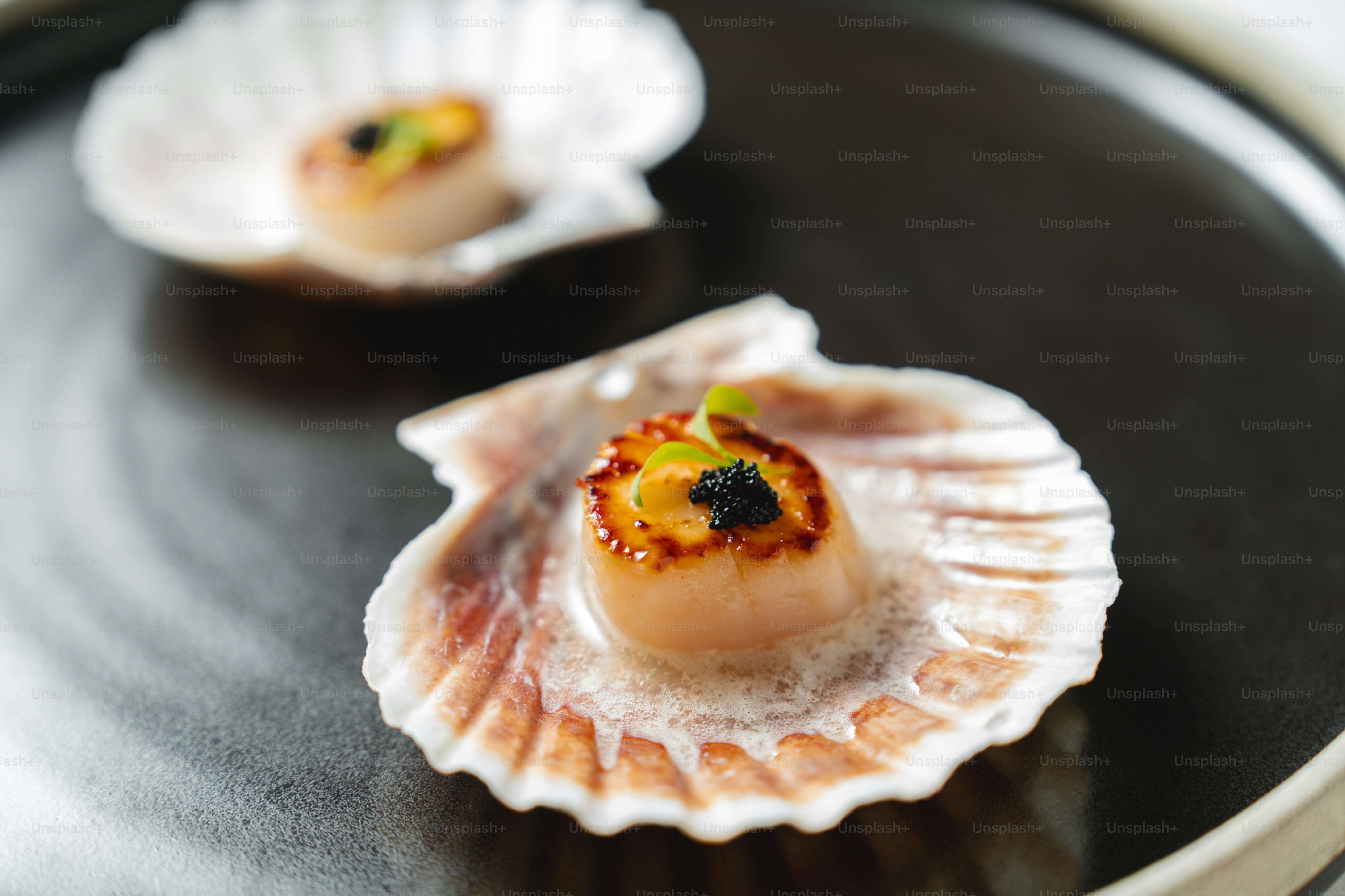 A close up of a plate of food with scallops