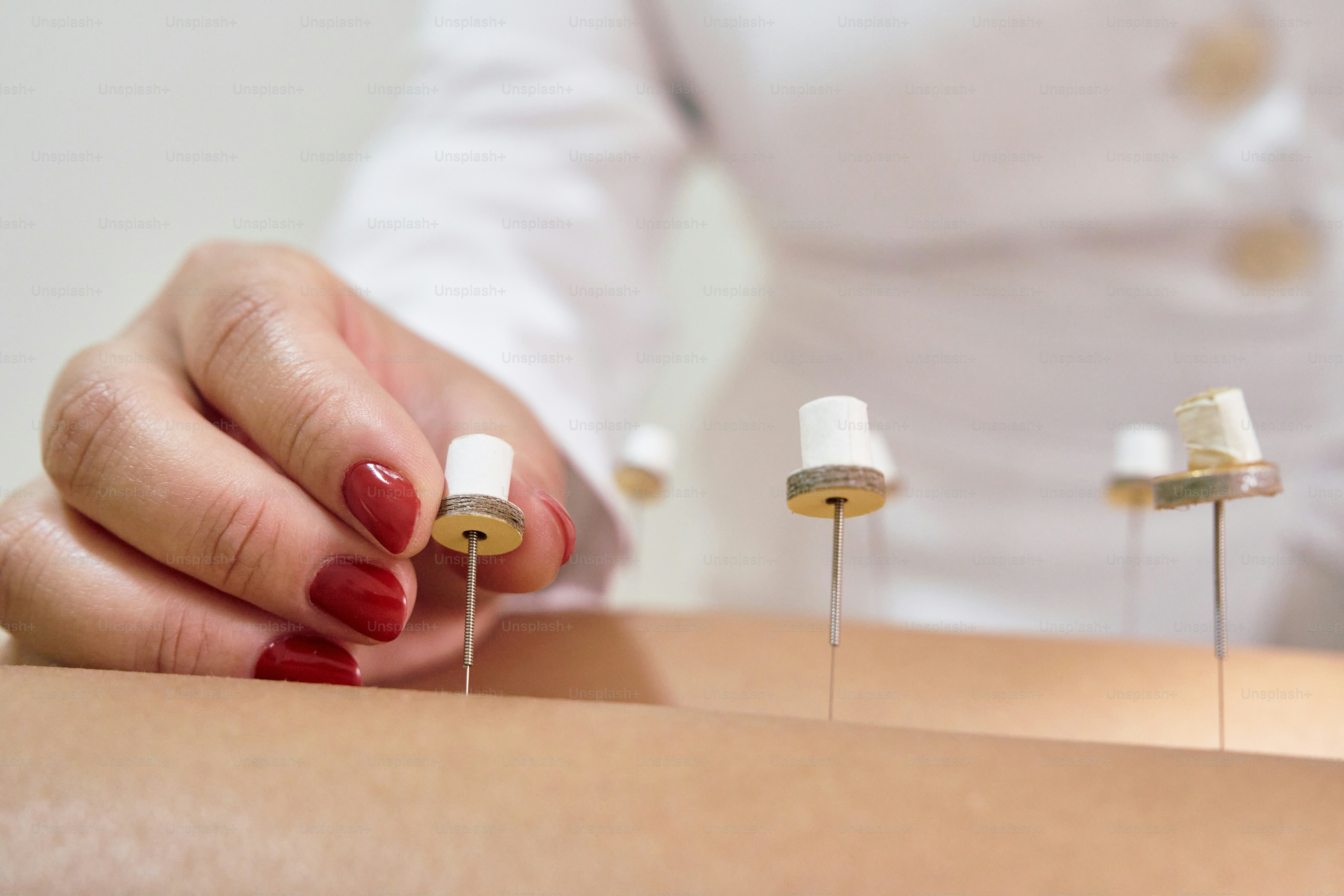 A woman is doing a manicure procedure on her arm
