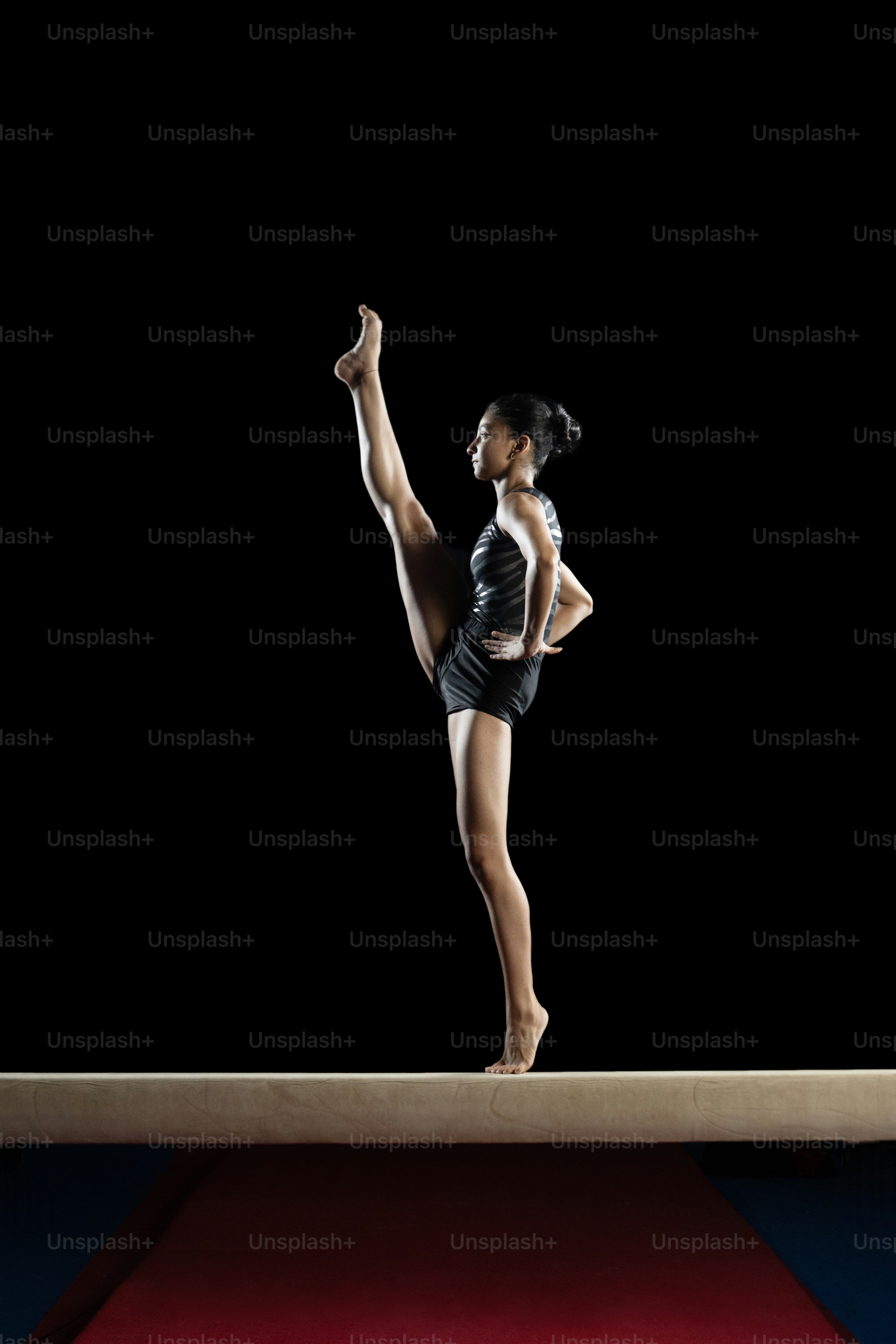 A woman standing on top of a red and blue floor