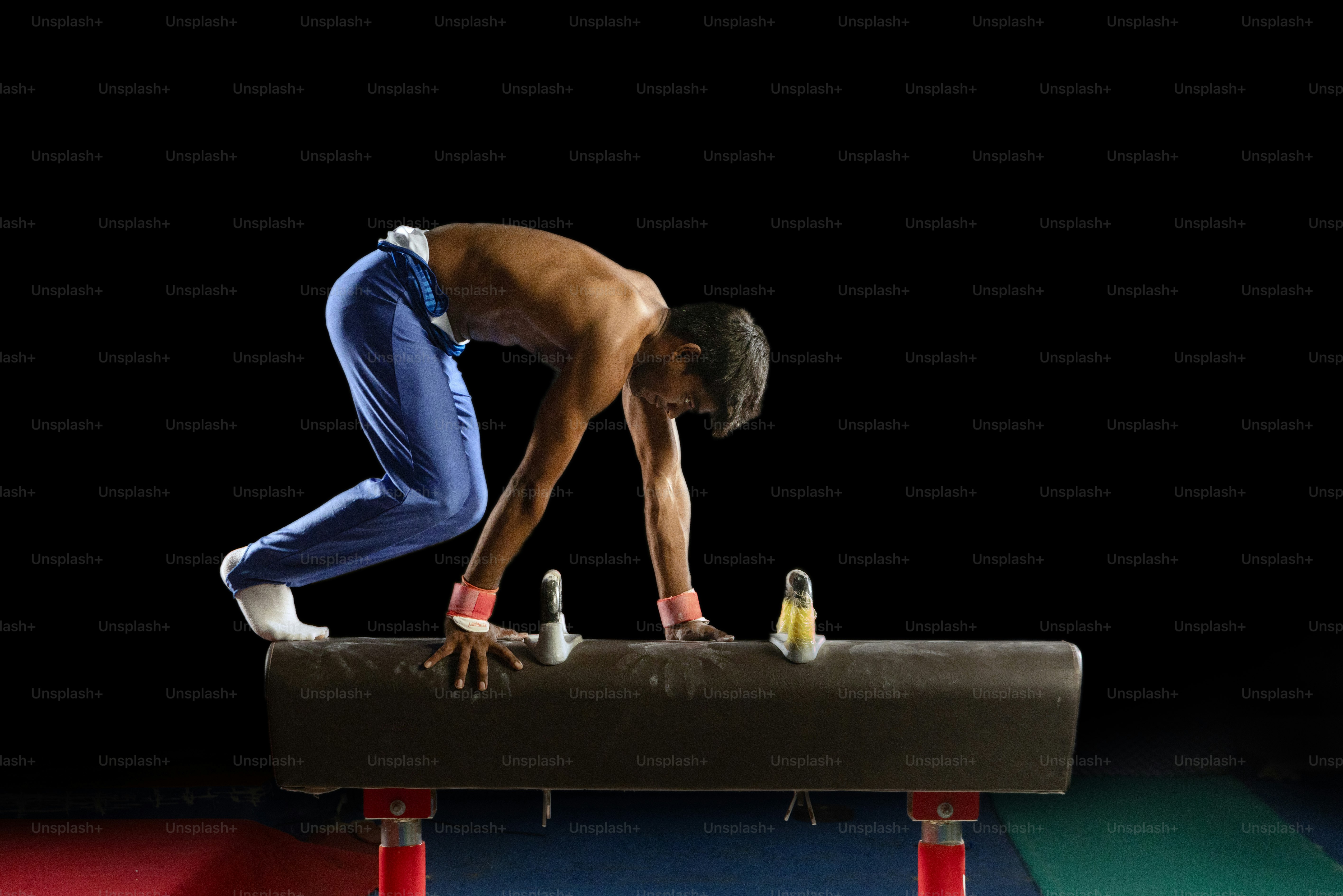 A man and a woman doing a handstand on a red carpet photo – Fitness ...